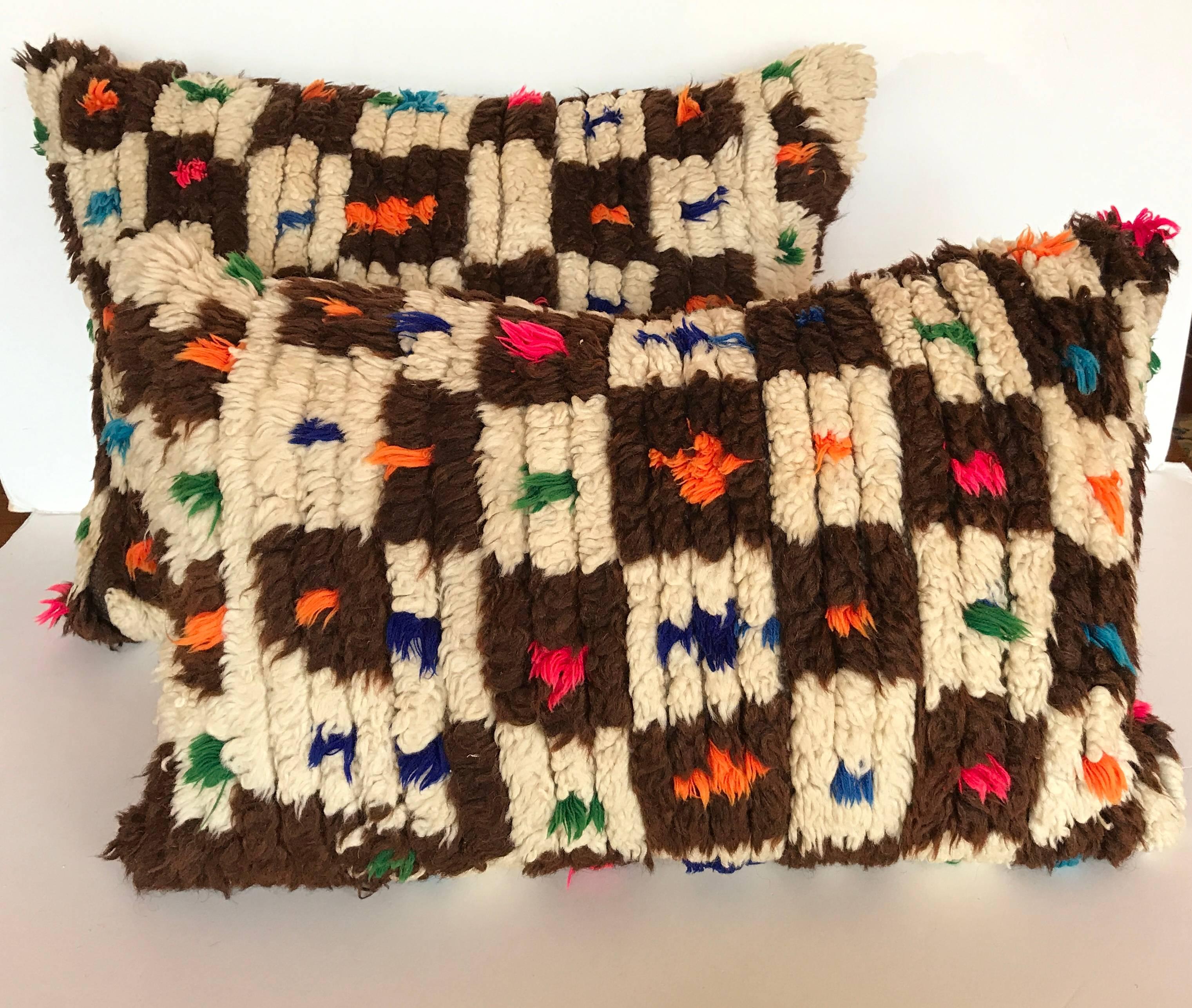 Custom pillow cut from a vintage hand loomed wool Moroccan Berber rug from the Atlas Mountains.  Wool is soft and lustrous with good color.  Pillow is backed in a linen blend, filled with an insert of 100% down and hand sewn closed.  We make our