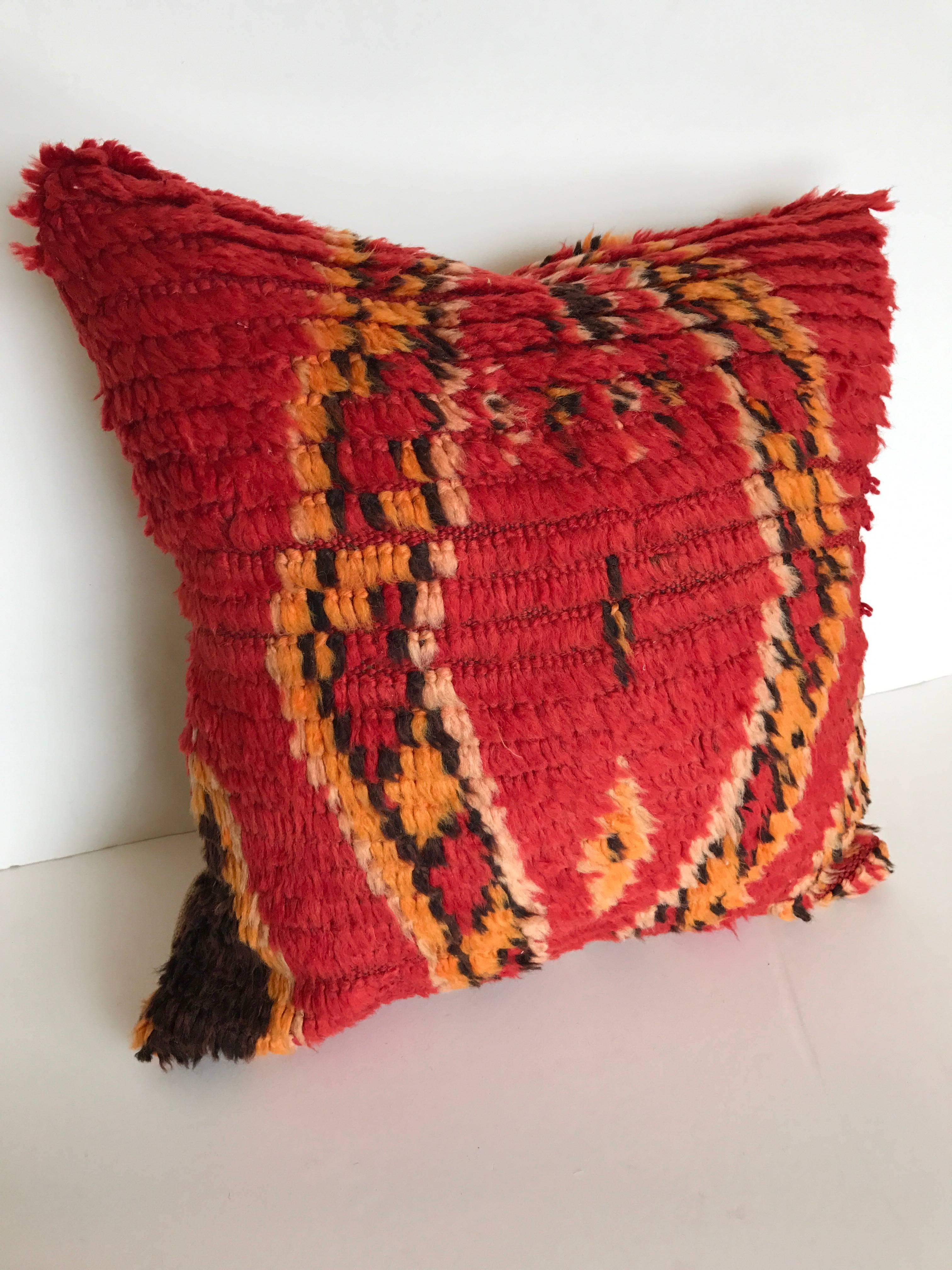 Custom pillow cut from a vintage hand loomed wool Moroccan Berber rug from the Atlas mountains.  Wool is soft and silky with all natural dyes.  Pillow is backed in linen, filled with an insert of 50/50 down and feathers and hand sewn closed.  We