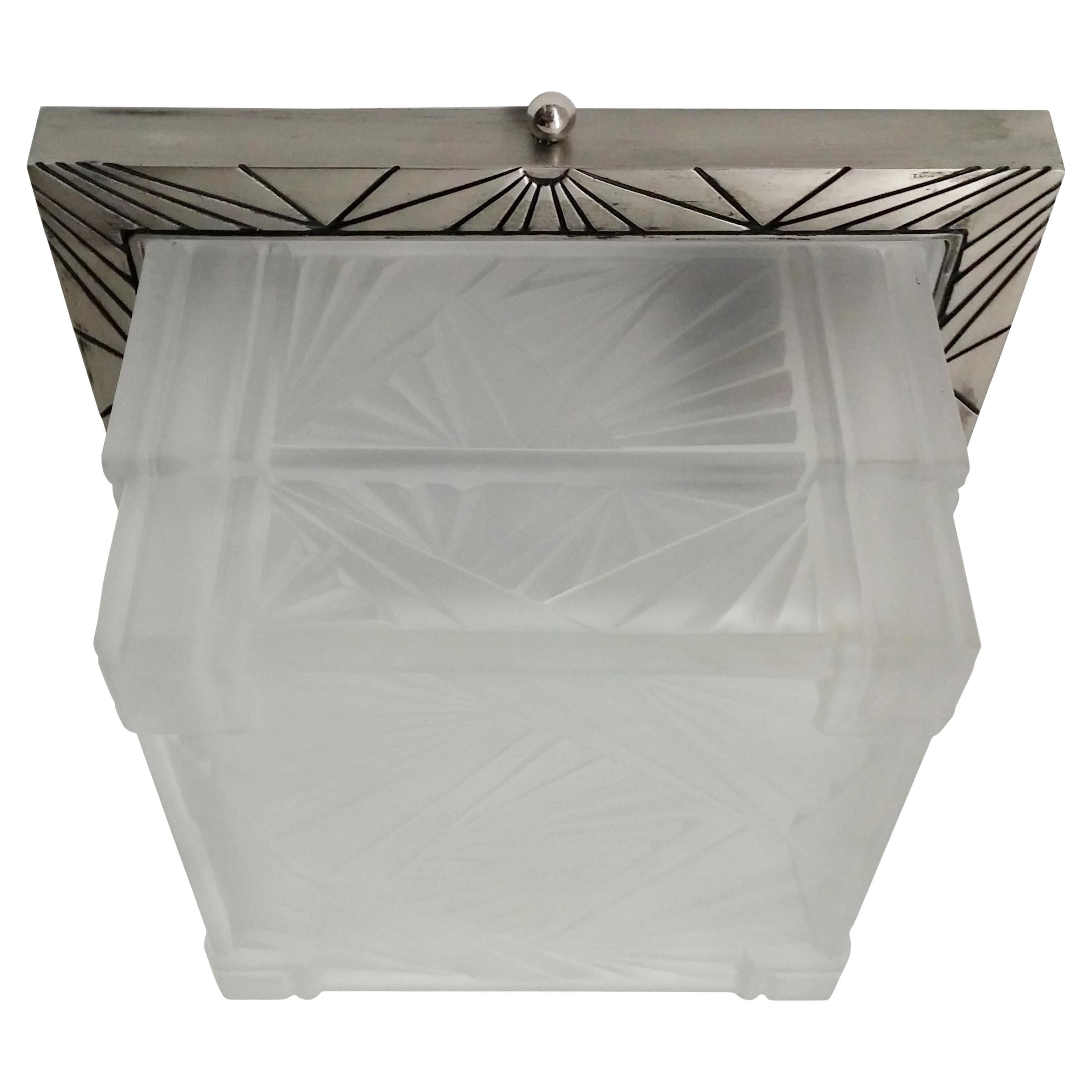 A French Art Deco square shape can be used as a flush mount or sconces decorated with a typical Art Deco geometric design in great condition. The shade is in clear frosted glass mounted on a matching nickeled bronze frame. The fixture has been