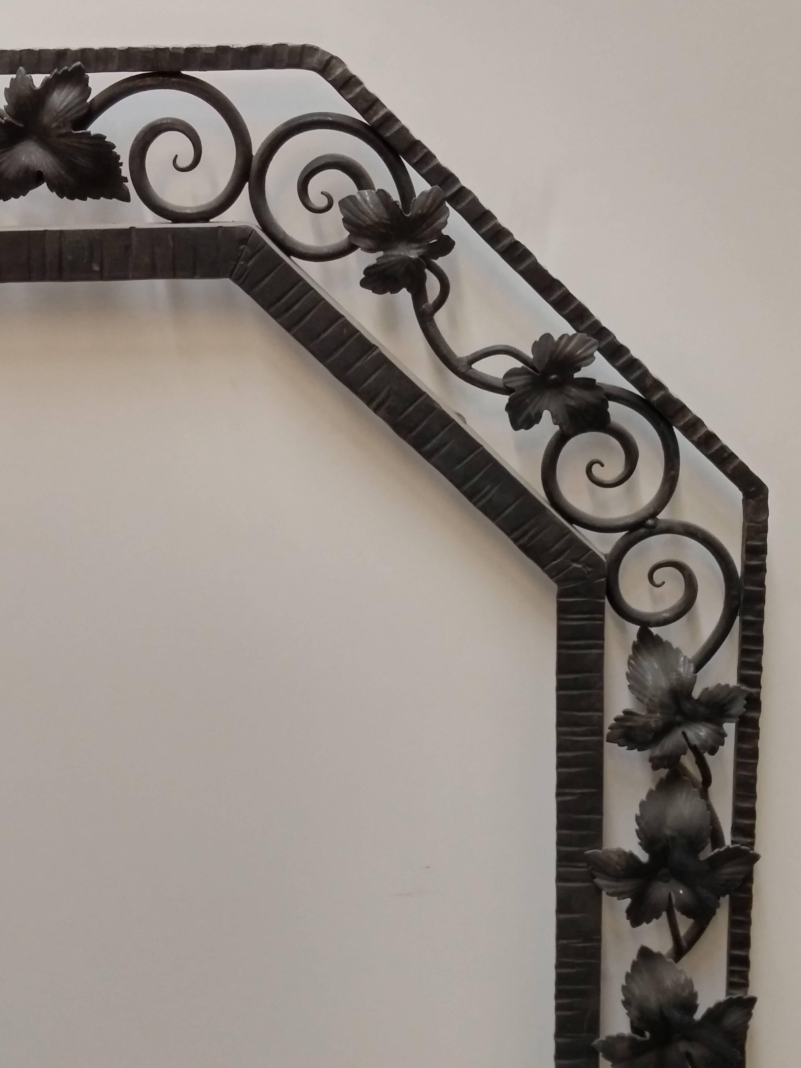 French Art Deco wrought iron mirror with hand-forged grapevine motifs. The frame will be accommodated with a beveled mirror. Pair available. Re-plating in different finishes upon request. Complimentary drop-off to the tri-state area. We are the rare