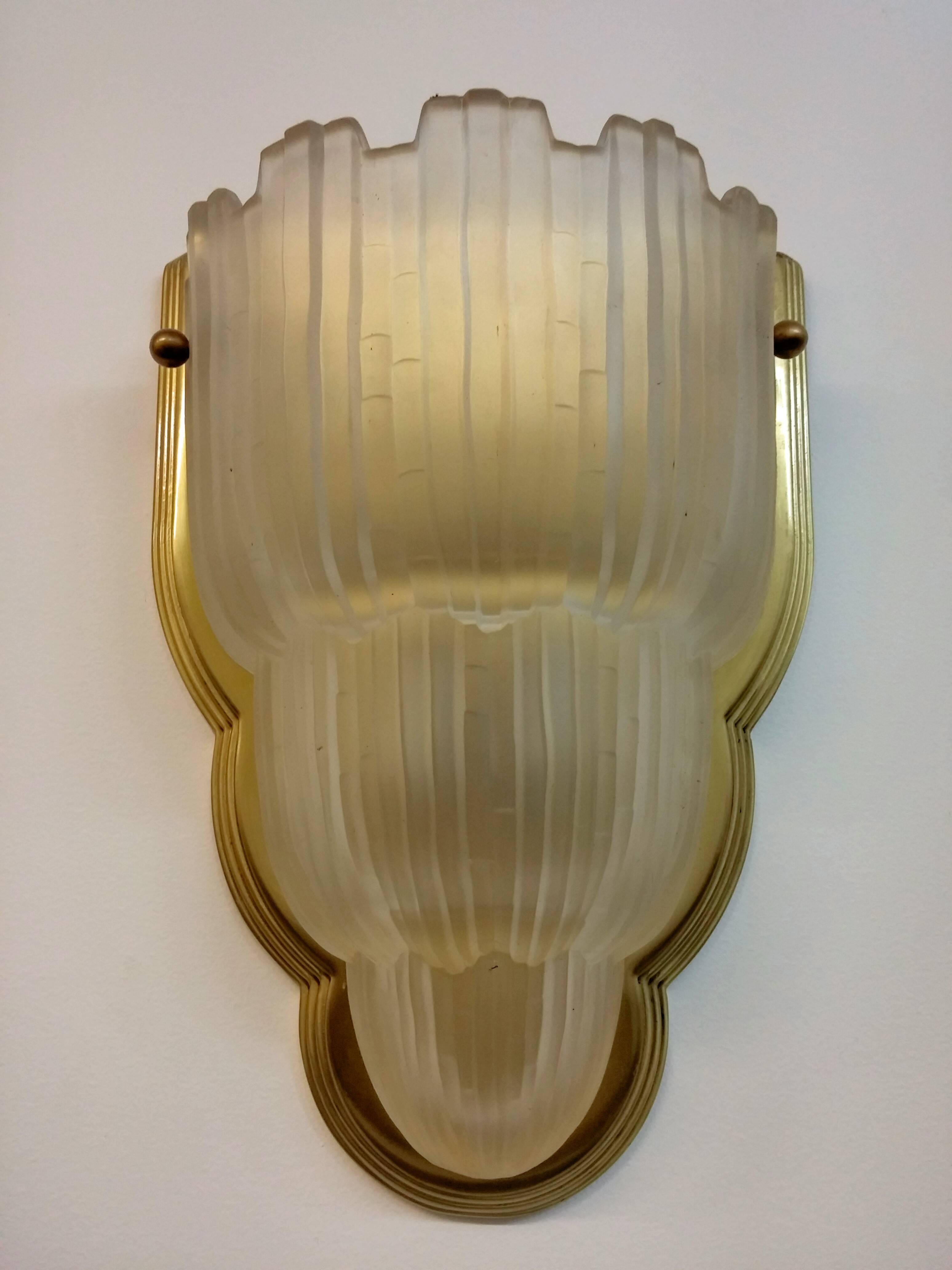 
This pair of French Art Deco sconces are called the " Waterfall " from the 1930's by Marius Ernest Sabino (1878-1961). Both shades are marked “SABINO 4645” and enhanced by typical Deco ribbed design in clear frosted glass with polished