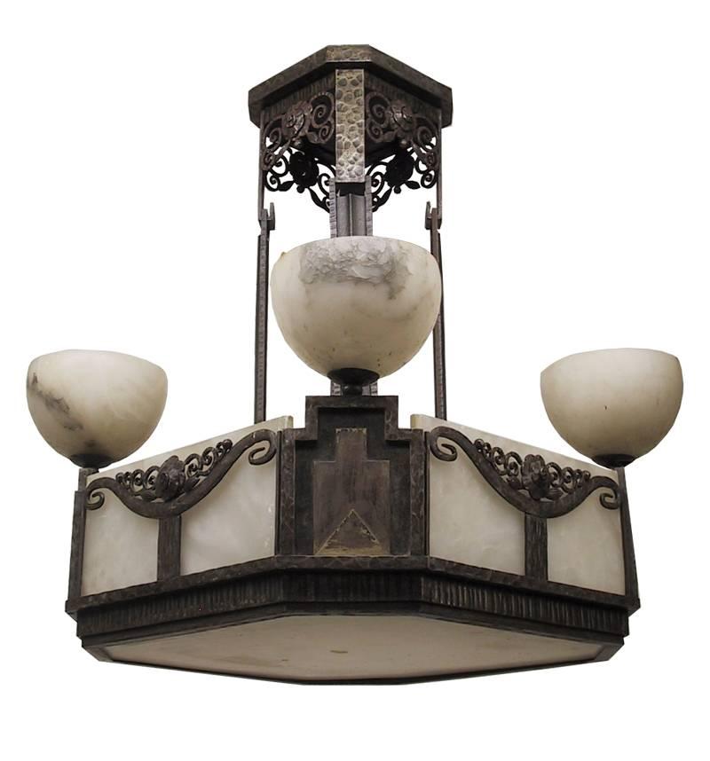 This exceptional and important French Art Deco square shape chandelier. Hand-forged wrought iron in different textures with fine intricate leaves and flower motifs. Original flat alabaster rectangle panel shades with four matching alabaster tulips
