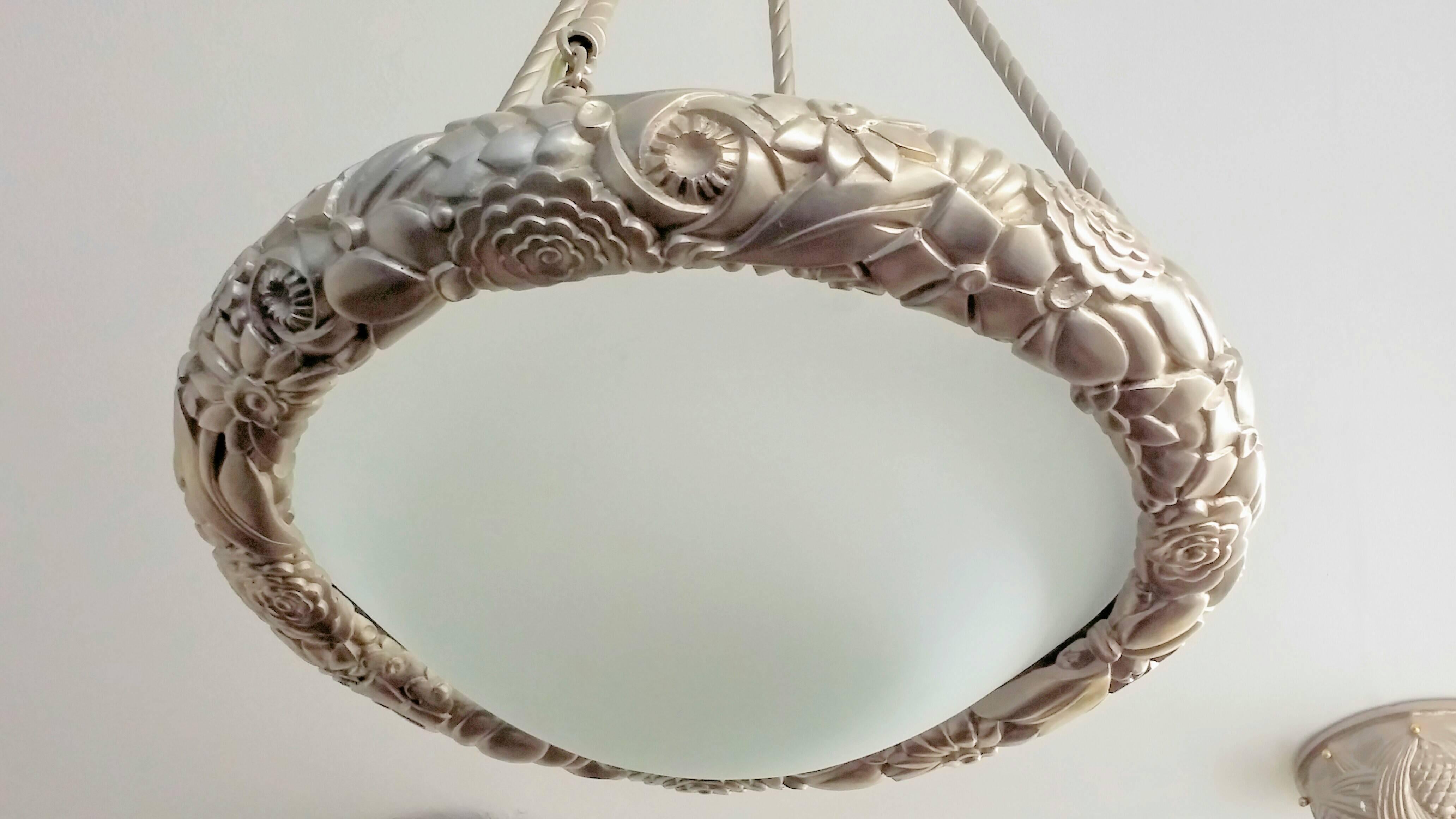 
A French Art Deco flower sphere pendant chandelier with intricate flower motif details, enhanced by concave frosted glass shade supported by four rods rope design with a smooth canopy in satin nickel. Fixtures can be re-plated, extended or