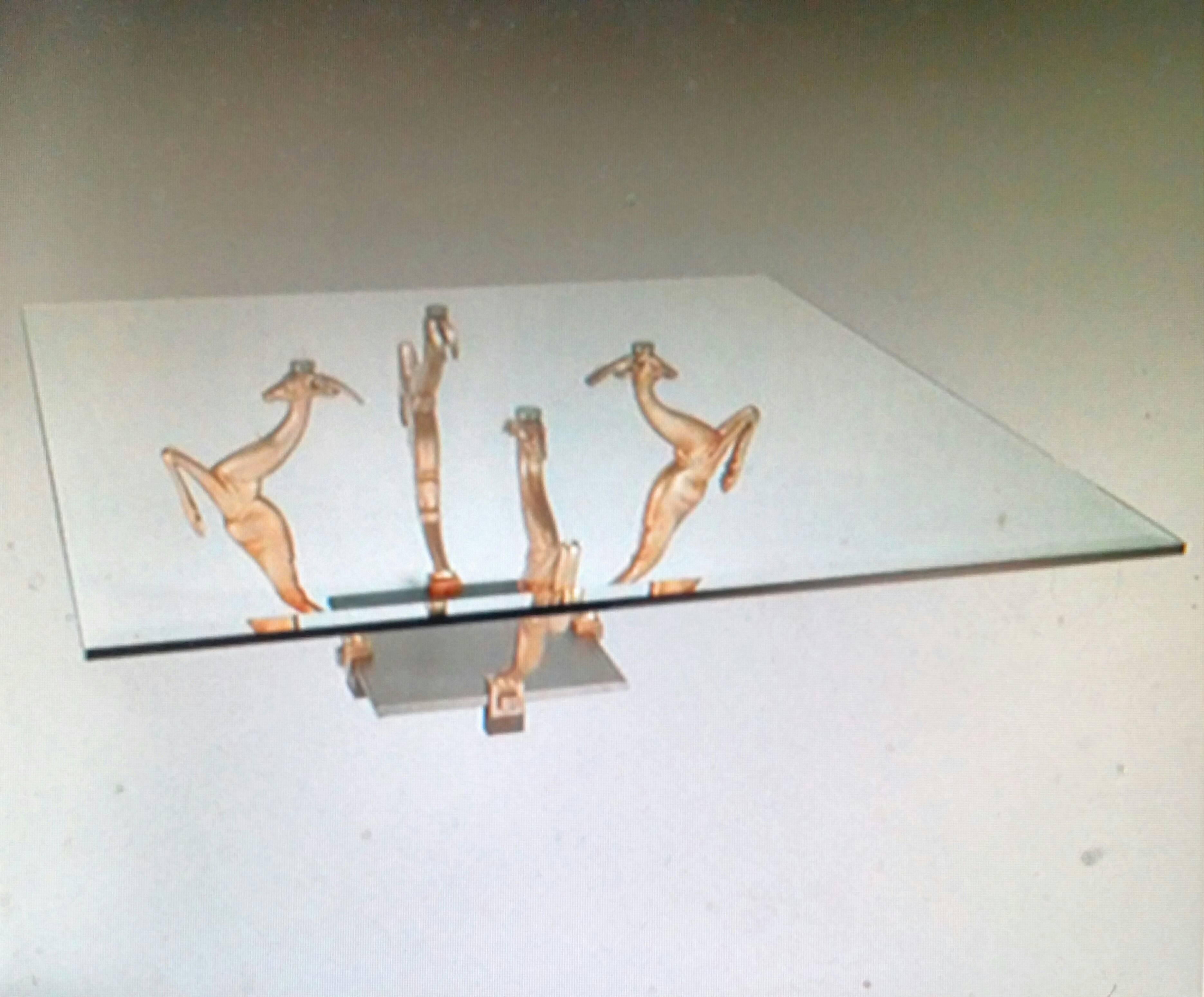 A French Art Deco two-tone coffee table with four solid satin bronze antelope figurines leaping gracefully from a quadrate platform of satin nickel finish raised by four legs. The table can be re-plated upon request. We are the rare source that