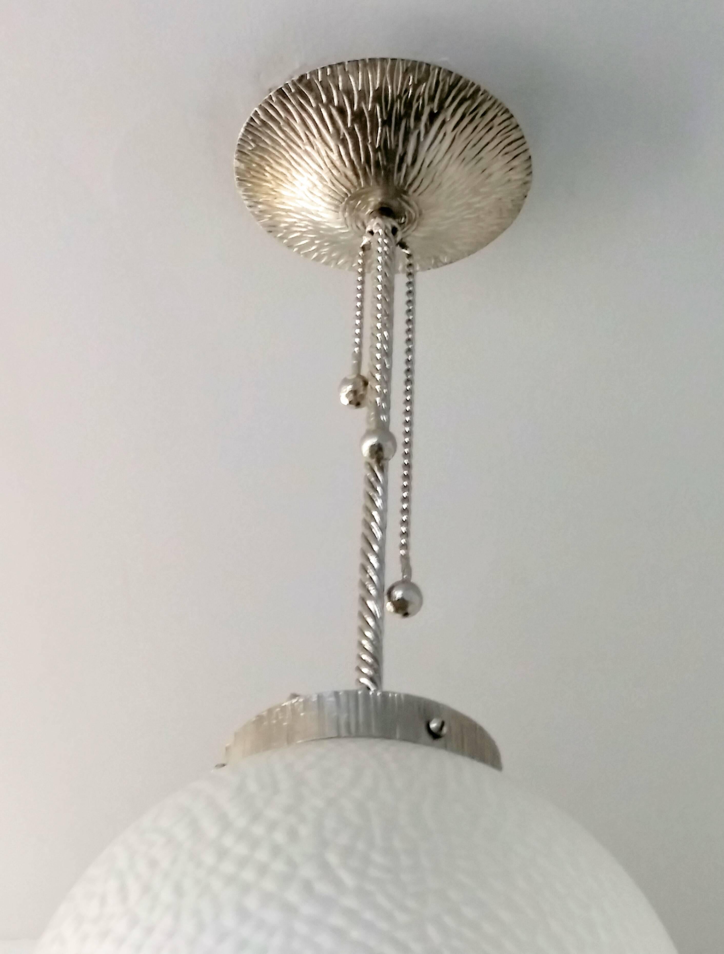 A French Art Deco wrought iron ball pendant chandelier. The fixture was re plated in nickel and re wired to U.S. standards which accommodate one household bulb (200 watts max)  Re-plating in different finishes upon request at no additional cost. We