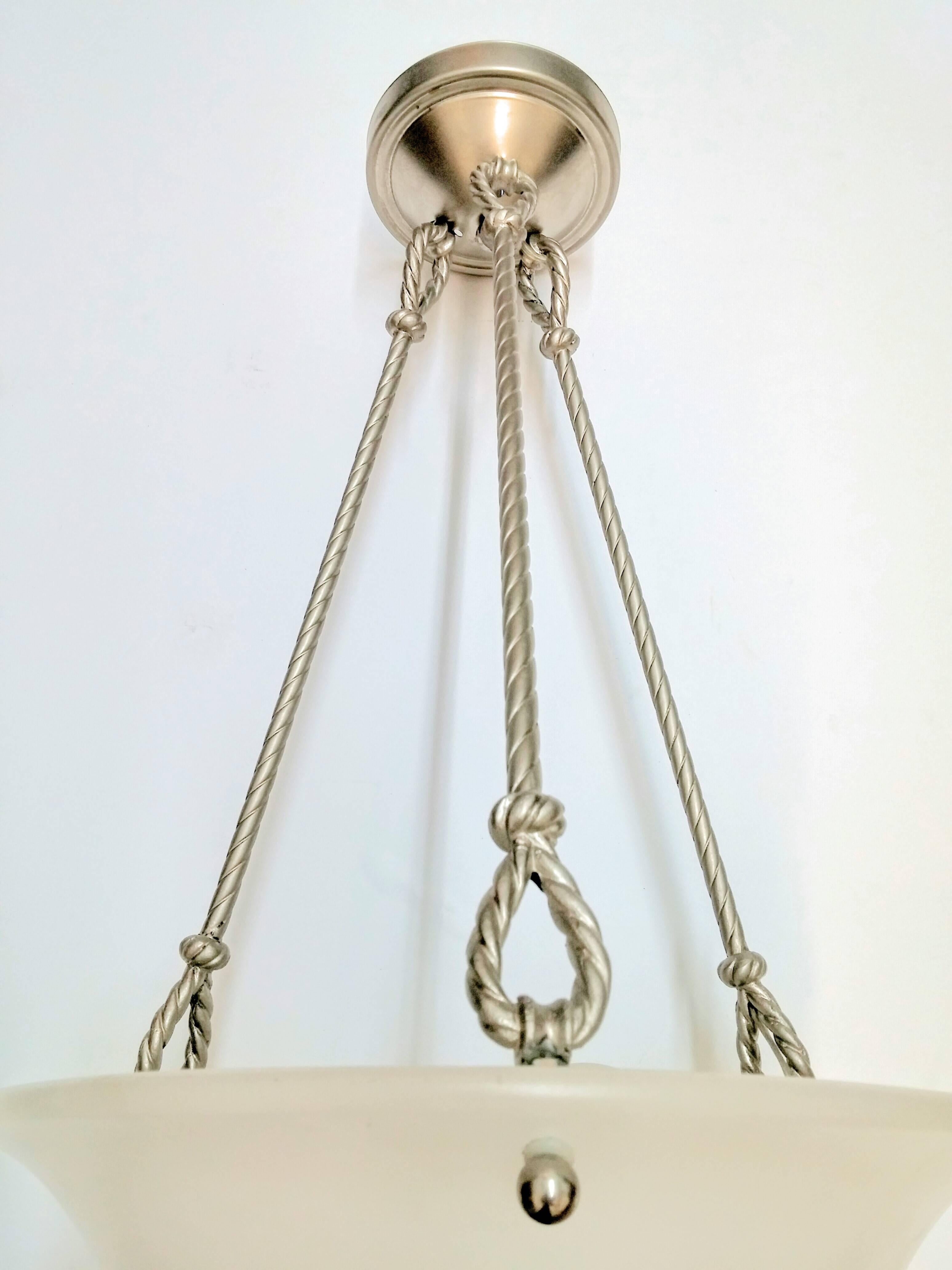 A French Art Deco pendant chandelier with a concave alabaster shade supported by four rods rope design with a smooth canopy in nickel. Pendant can be re-plated or shorten upon request at no additional charge. Alabaster shade can be substituted to
