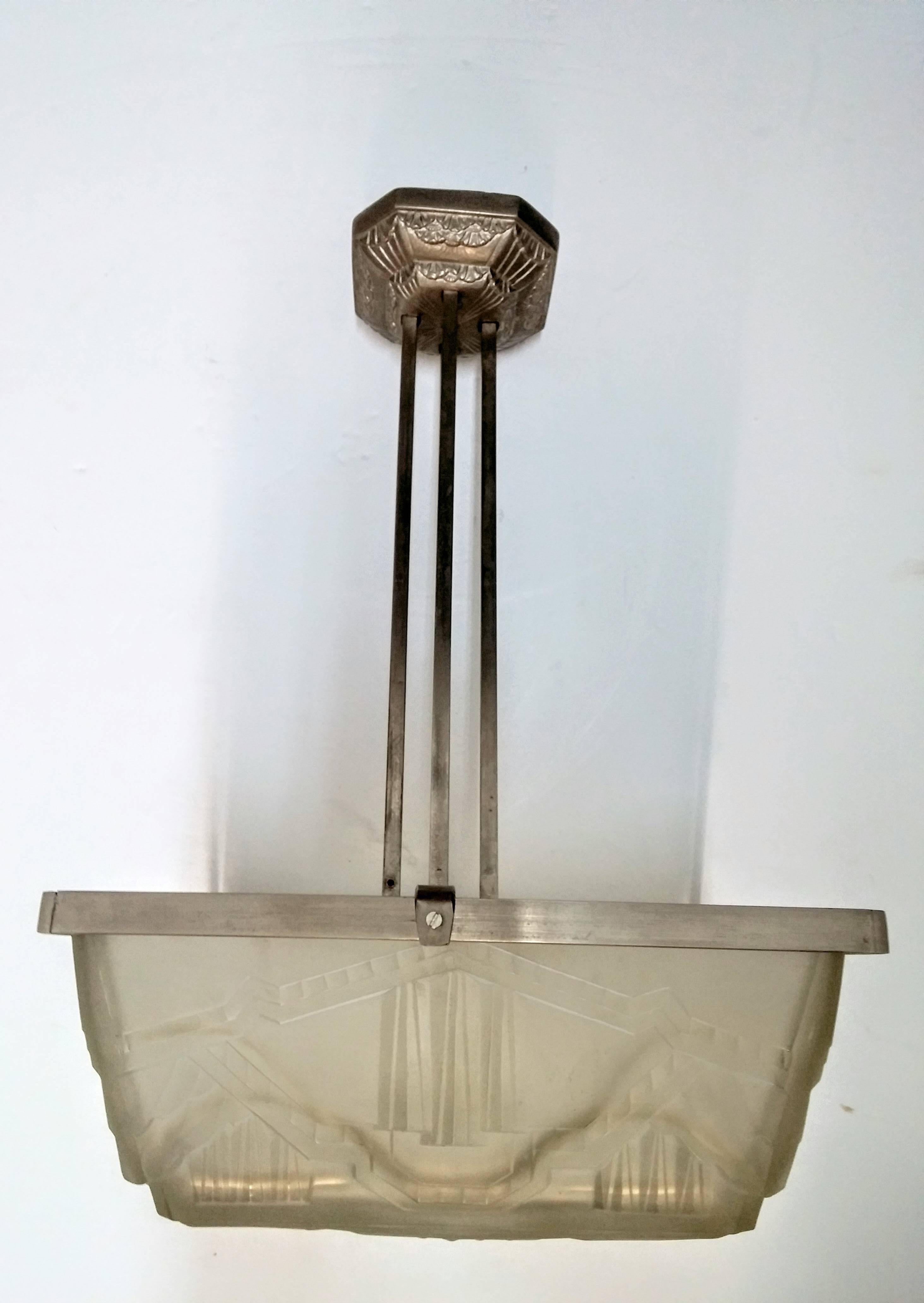 
A stunning rare French Art Deco square shaped pendant chandelier was attributed to the French artist 