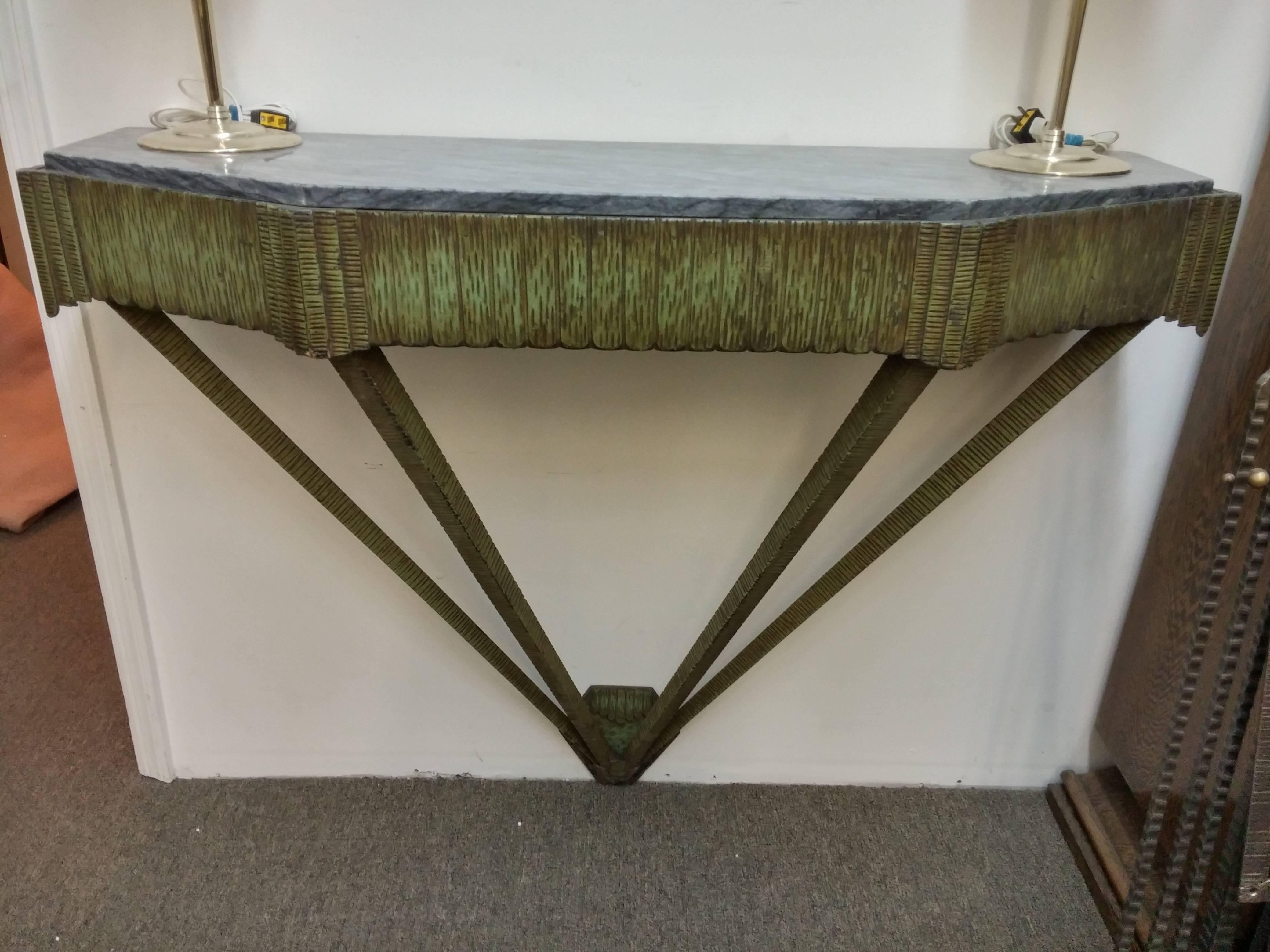 A Classic French Art Deco wooden carved console in green patina. Polygonal top shape in predominately geometric motifs with fine carving details. The console features a beautiful matching grey and white marble top. We are the rare source that has