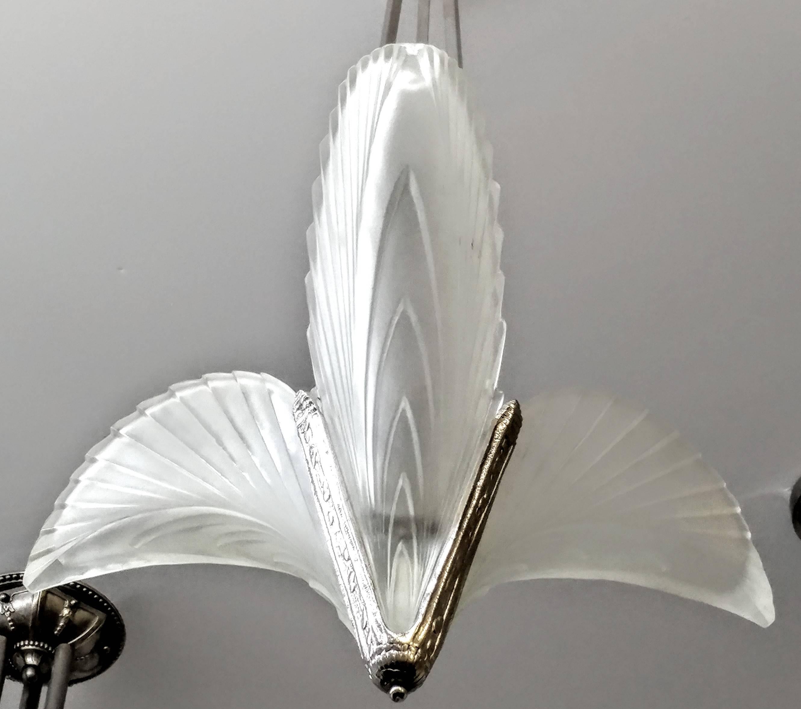 French Art Deco triangilar chandelier with clear frosted glass shades decorated with geometric feather motif mounted in polished silvered bronze frames. 

Lampen offers complimentary custom drop (extended or shorten from original dimension) and