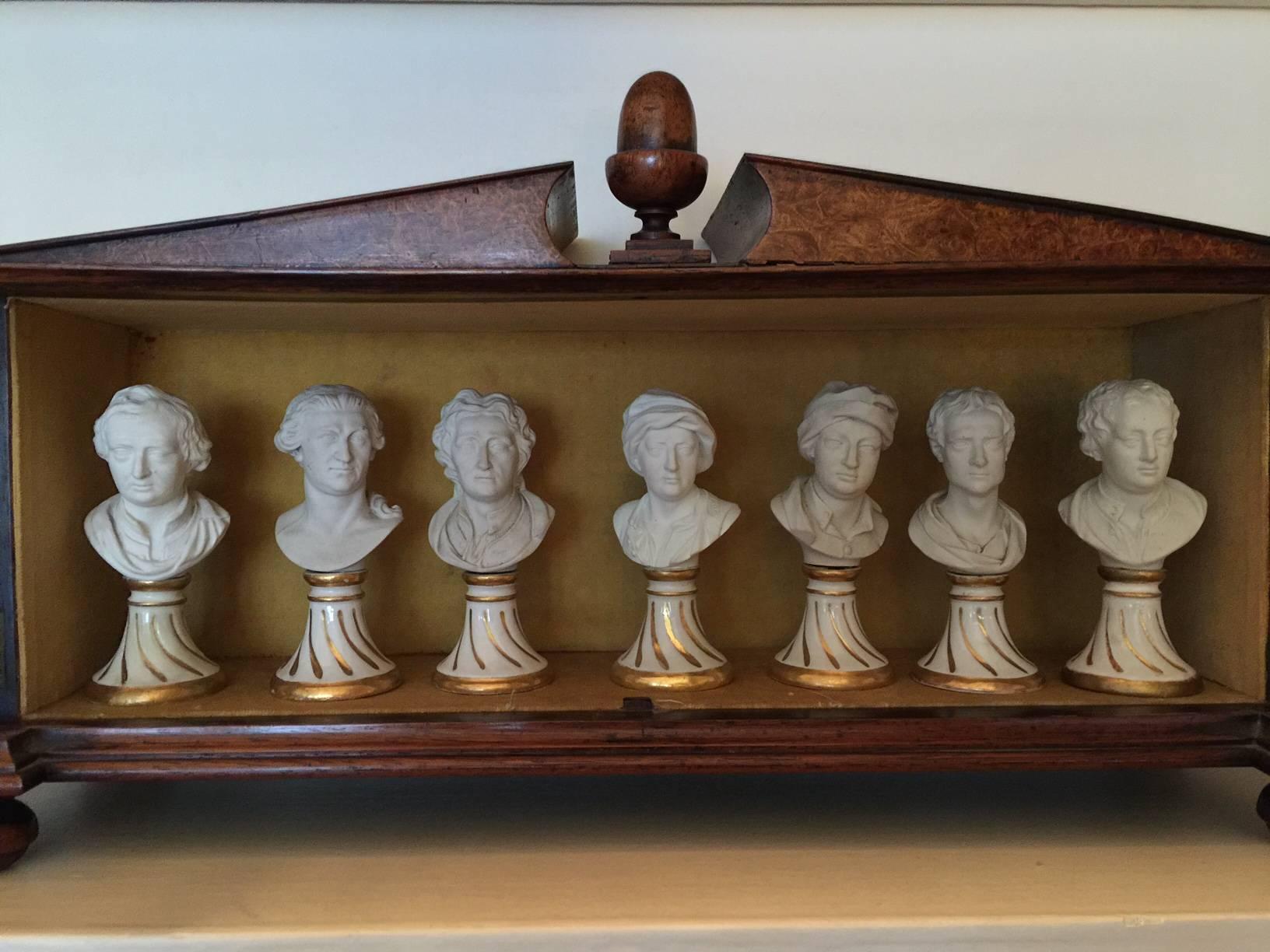 Seven Furstenberg miniature busts of English men of letters, early 19th century together with a William IV Amboyna two-door glazed cabinet. Including,
Locke, Dryden, Garrick, Pope.