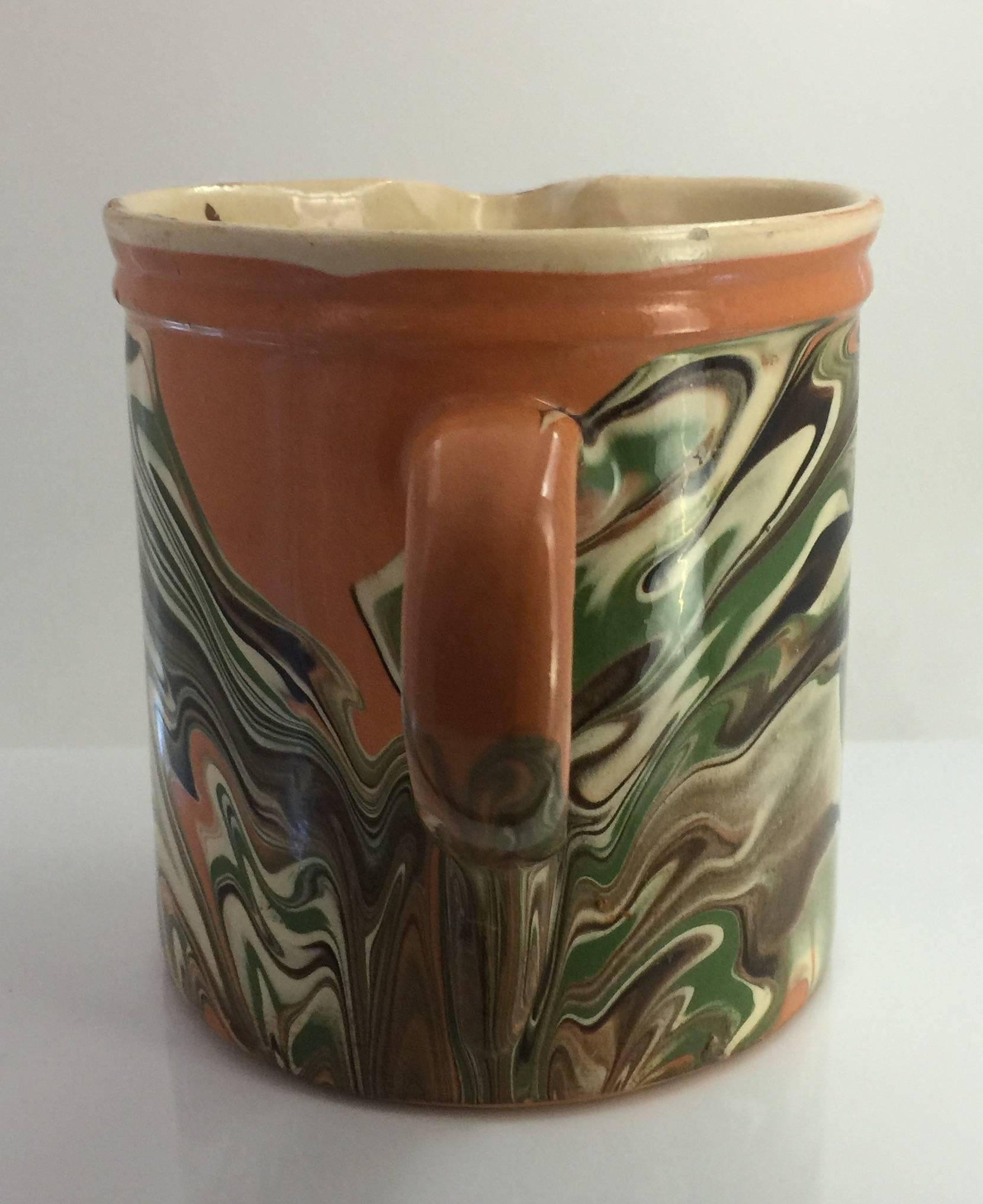 19th century French Jaspe pitcher with marbelized decoration on a peach ground.