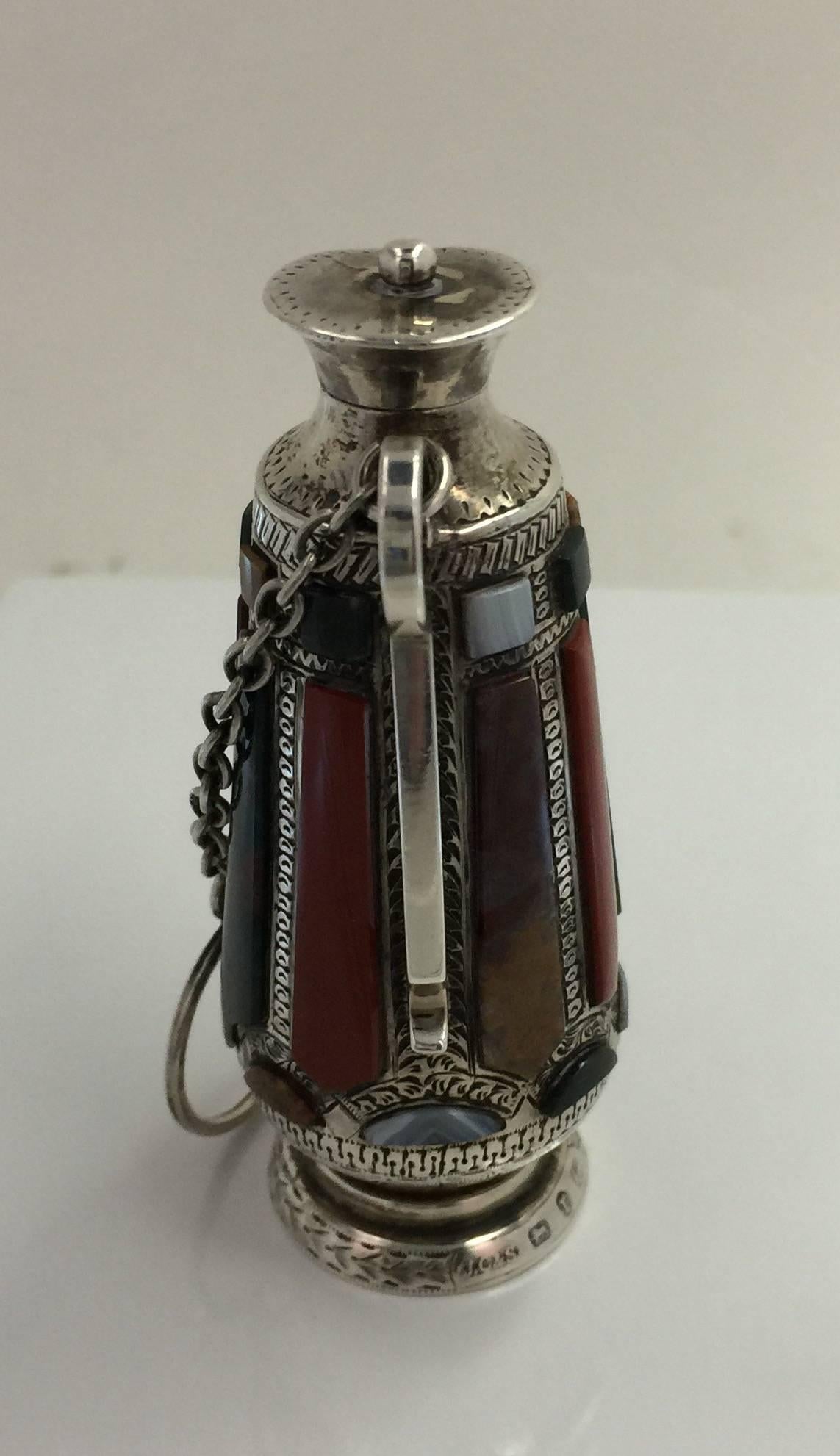 The flask hangs from a chain from a chatelaine, with hallmarks on base and underside for Birmingham, England, 1875.