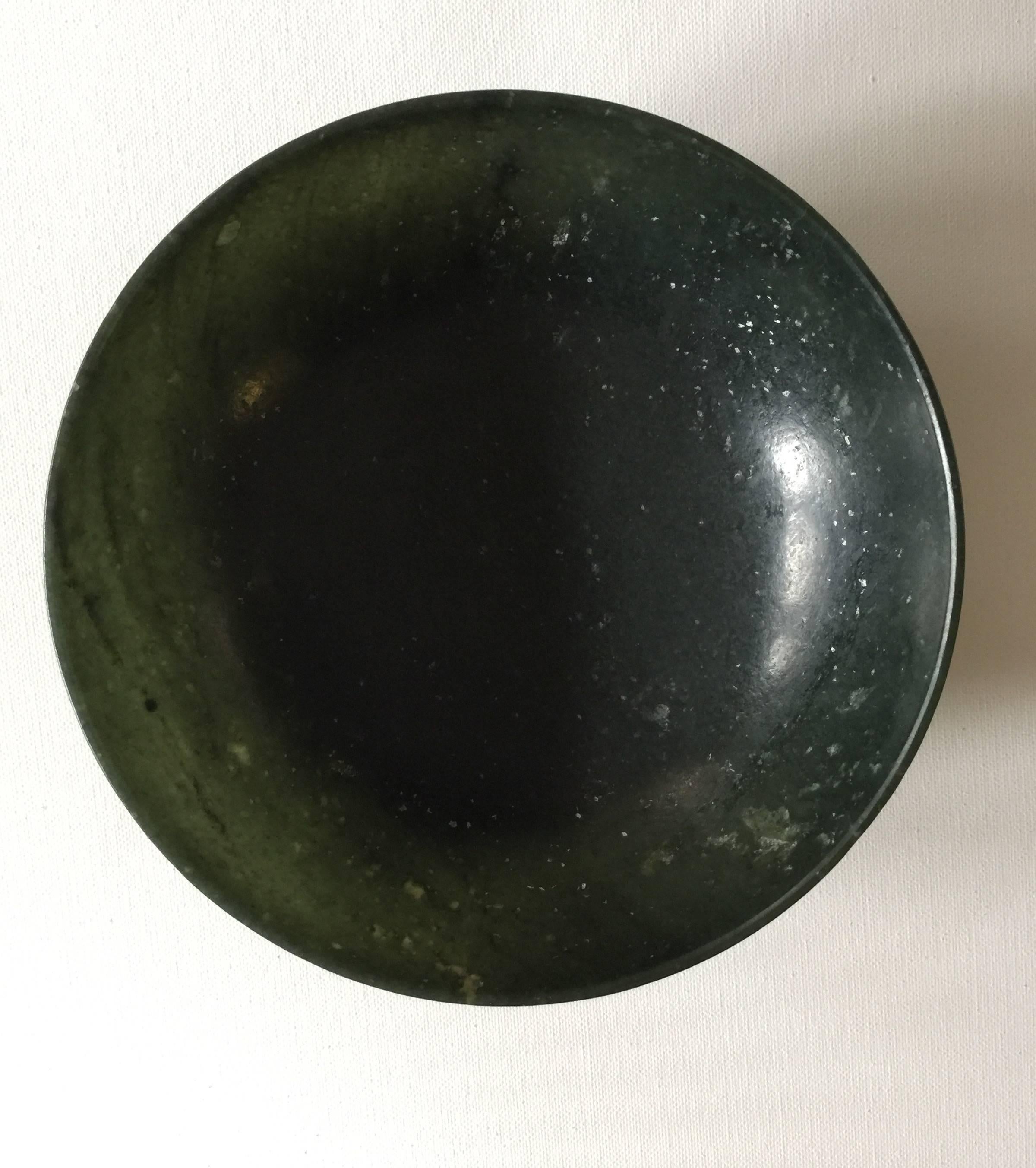 A dark round jade bowl, Chinese, 19th century.
