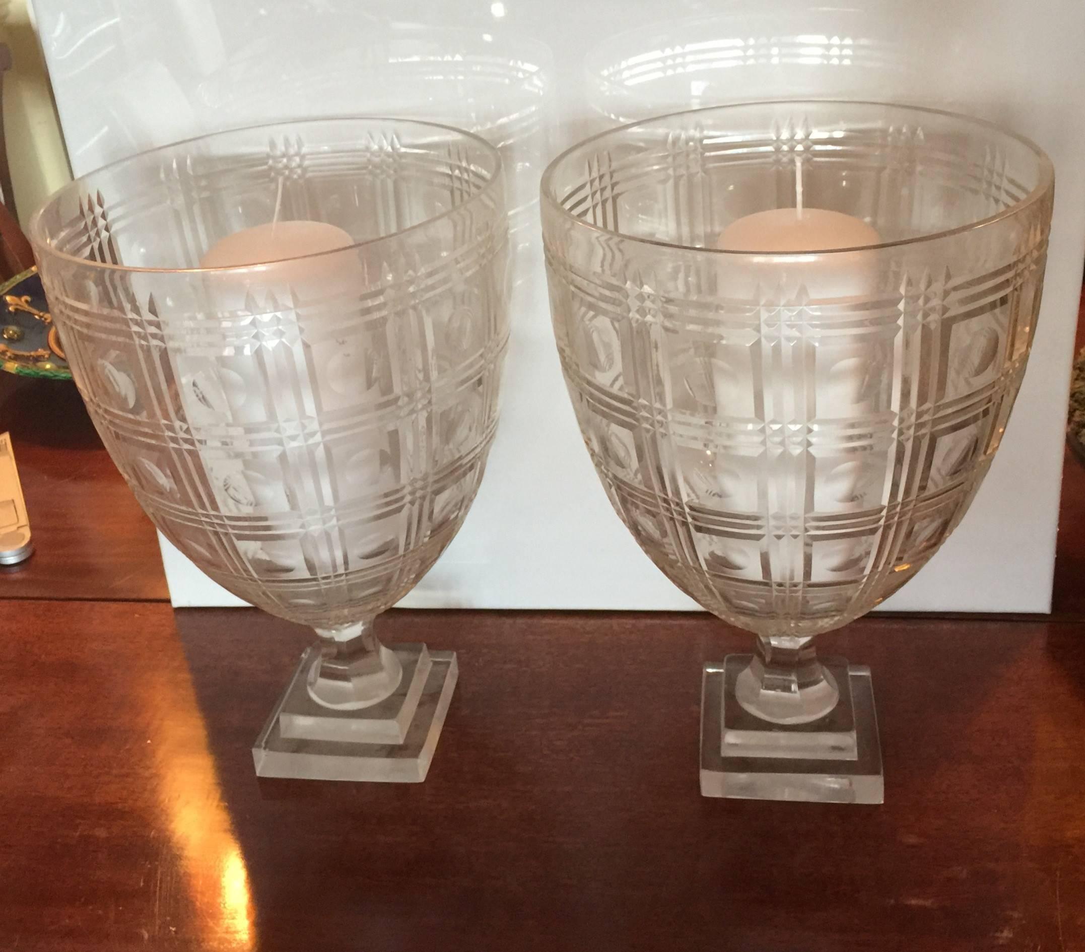The large photophores, also know as hurricane shades or candle holders, incised with circles within a trellis pattern.
