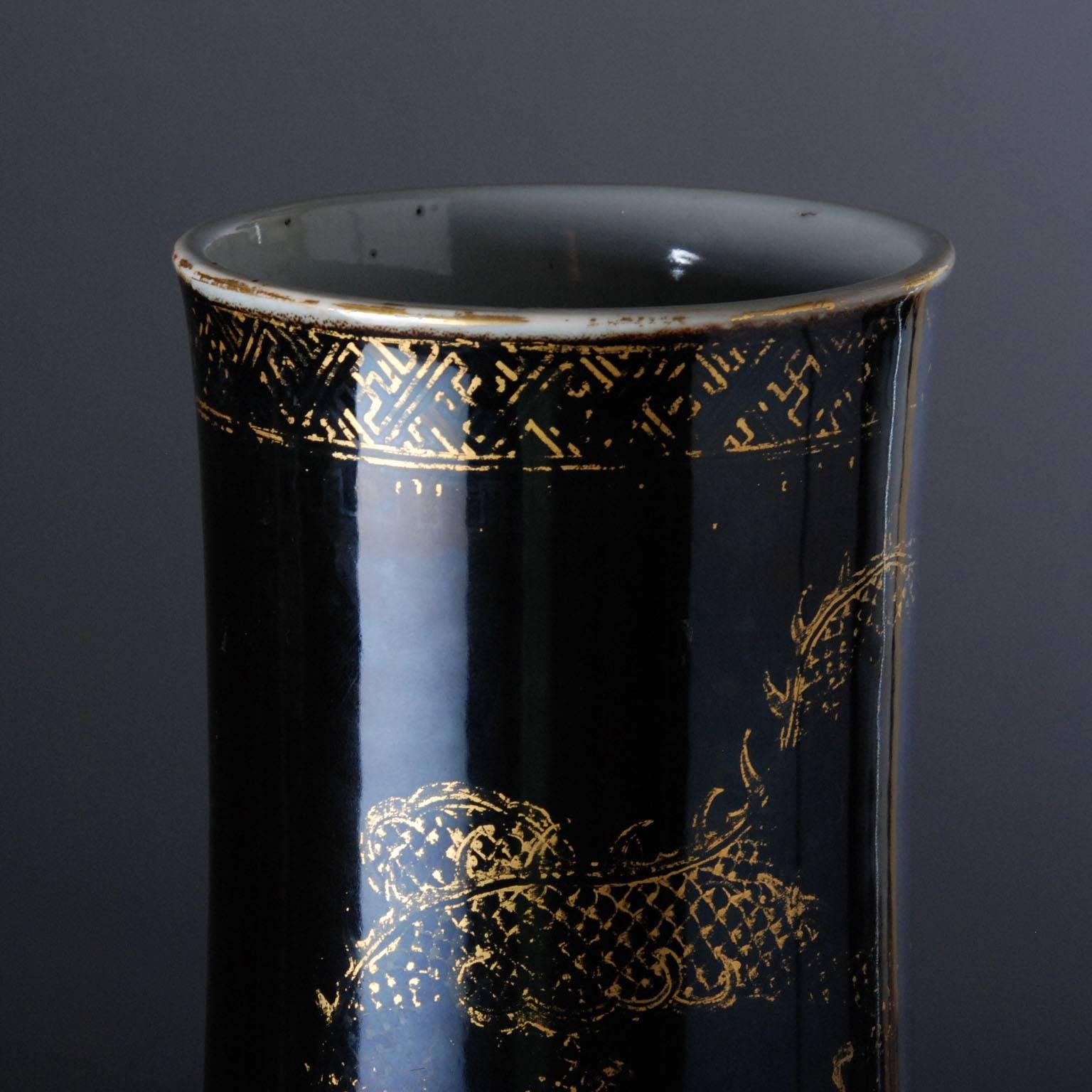 This large vase is decorated in so called ‘mirror black ‘ enamel creating a smooth surface that almost functions as a mirror. The dragons’ decoration in gold is applied over the glaze. In China, the dragon is the symbol of the emperor. The dragon is