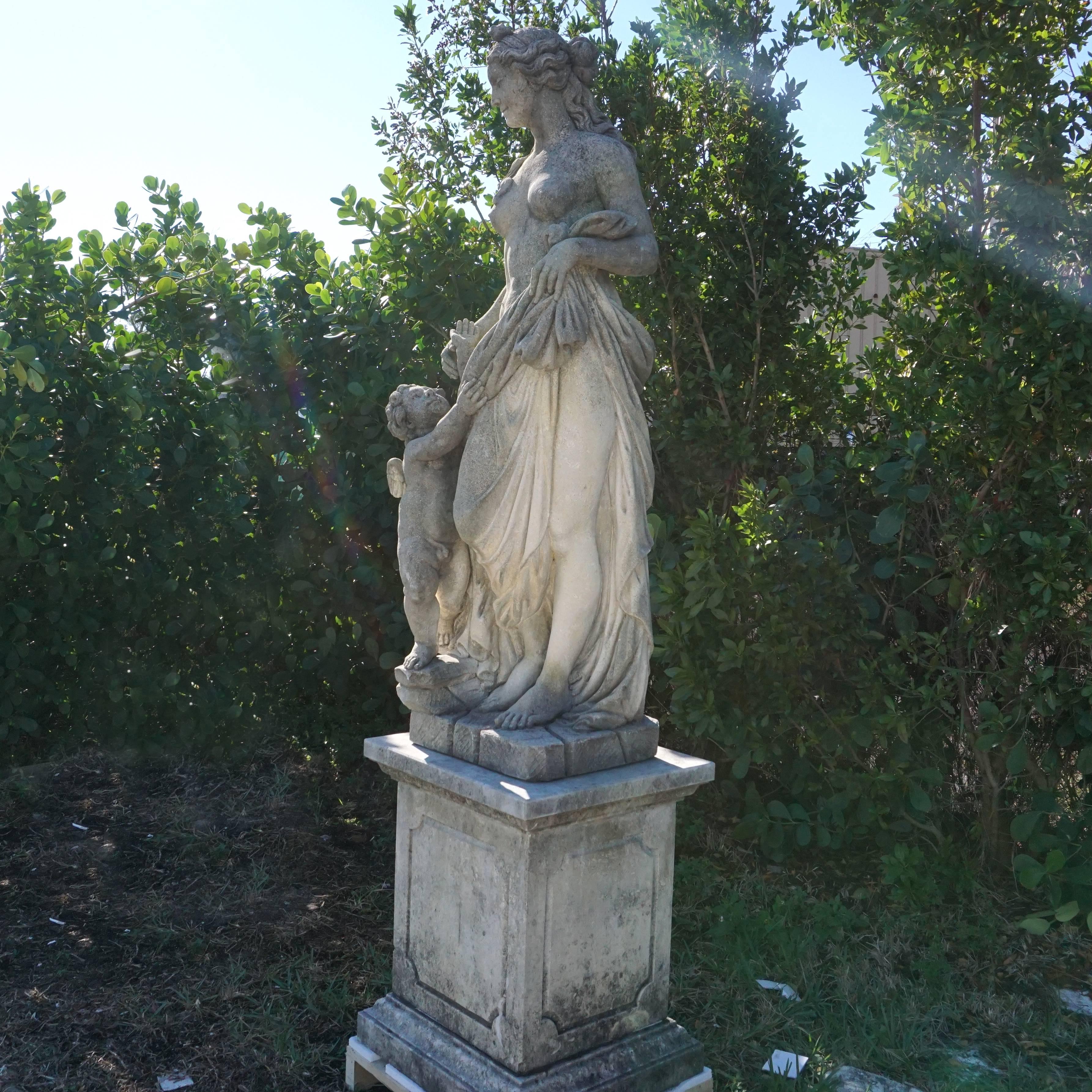Early 20th century, Mater Matuta, a Latin goddess became Aurora, a Roman goddess. This garden statue has been meticulously executed, a plinth in limestone is provided. Aurora is looking towards the cherub, similar statues were attributed to the