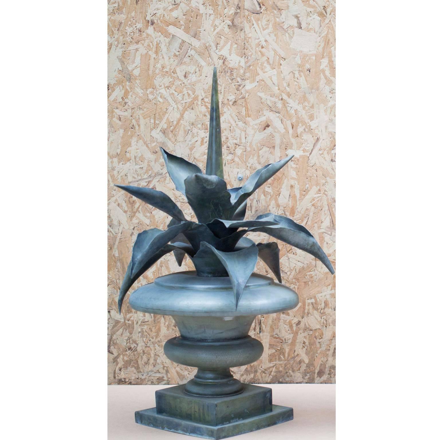 Pair of zinc agave mounted into urns. Fine 20th century artistic metal works with a heavy lip on the square double bases. Typical flower ornament, mostly used in the architecture of the 18th century as finials on pilasters throughout France and