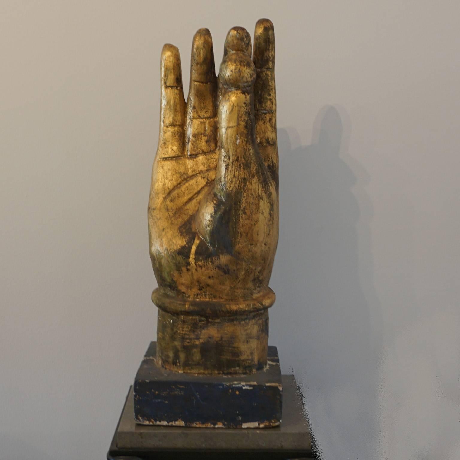 Hand-carved hand holding the pearl of wisdom. The pearl 
was used as a symbol of the most valuable treasure, wisdom,
circa 1880, Burma.