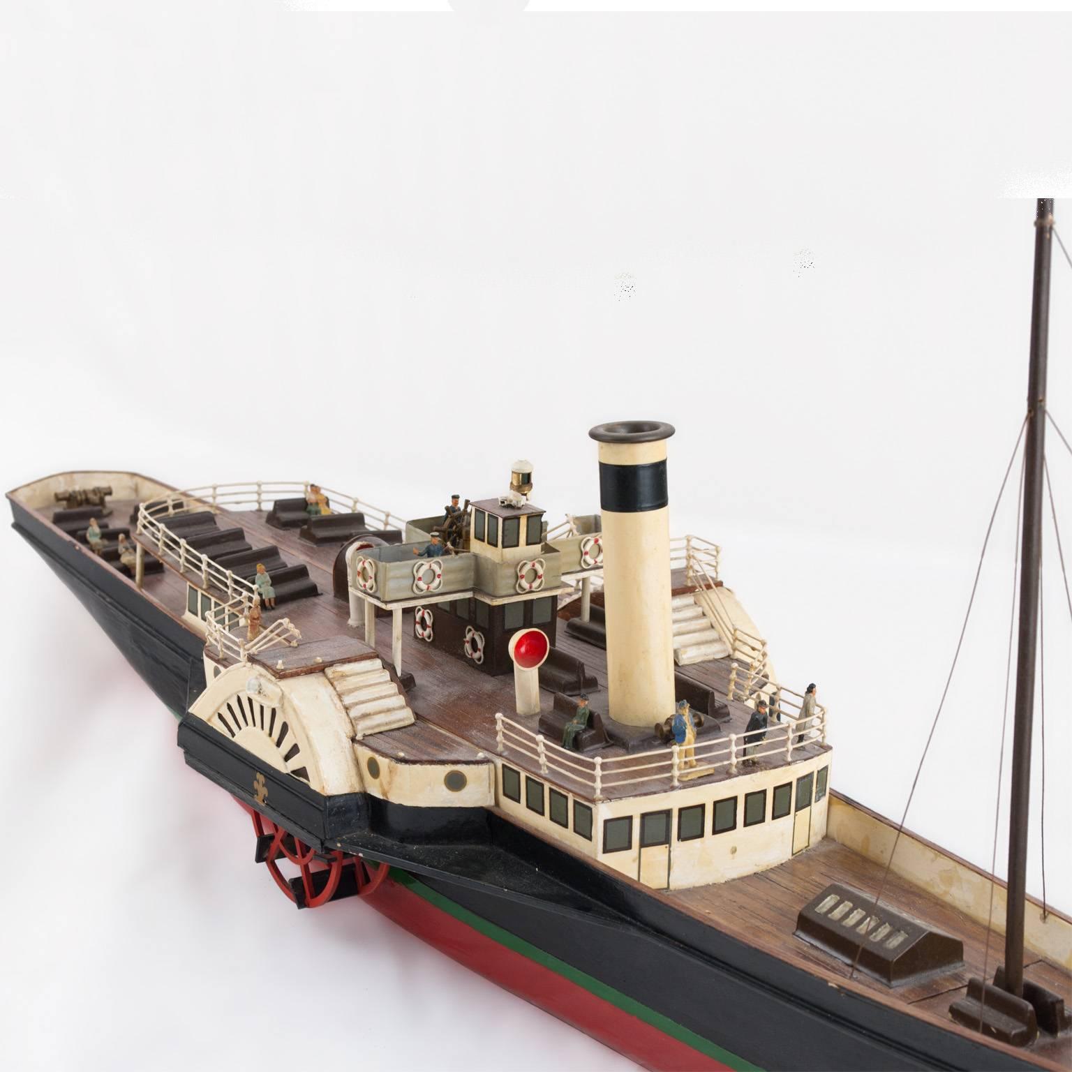 A vintage, detailed model of a side wheeler steam boat powered by a steam engine that drives peddle wheels to propel the craft through the water. This models was made in Bakelite. Handcrafted wooden model boat fully assembled, circa 1910,