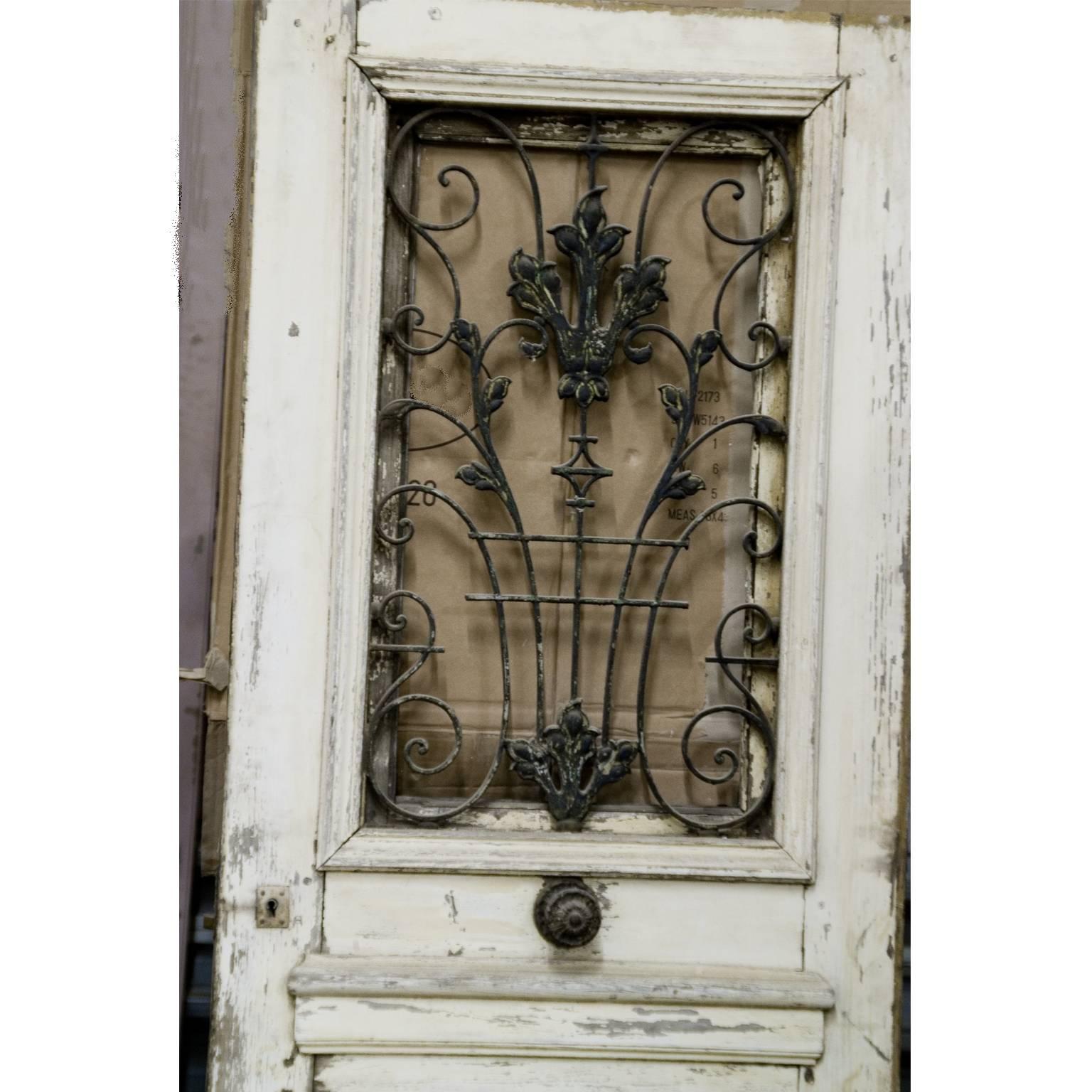 Beautiful and rare painted oak guest house entrance door with charming wrought iron grill with leaf decor and scrolls, original doorknob,
circa 1790.

 