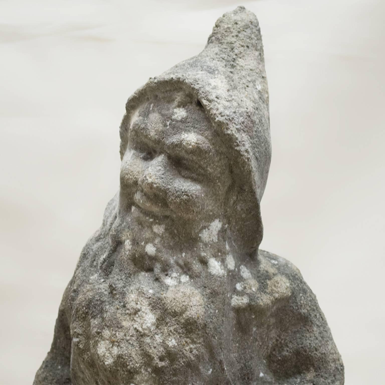 Charming and rare to find 20th century small garden statue of a sitting friendly gnome in Pierre Composee. Prov. Arles, France.

