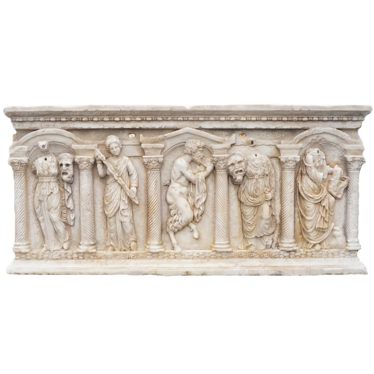 An antique Italian large rectangular coffin or basin planter in the style of the late Hellenistic period with minor repairs. Features impressive carvings of the art muses, goddesses, dentil molded rim and rope twist along the columns. Hand carved in