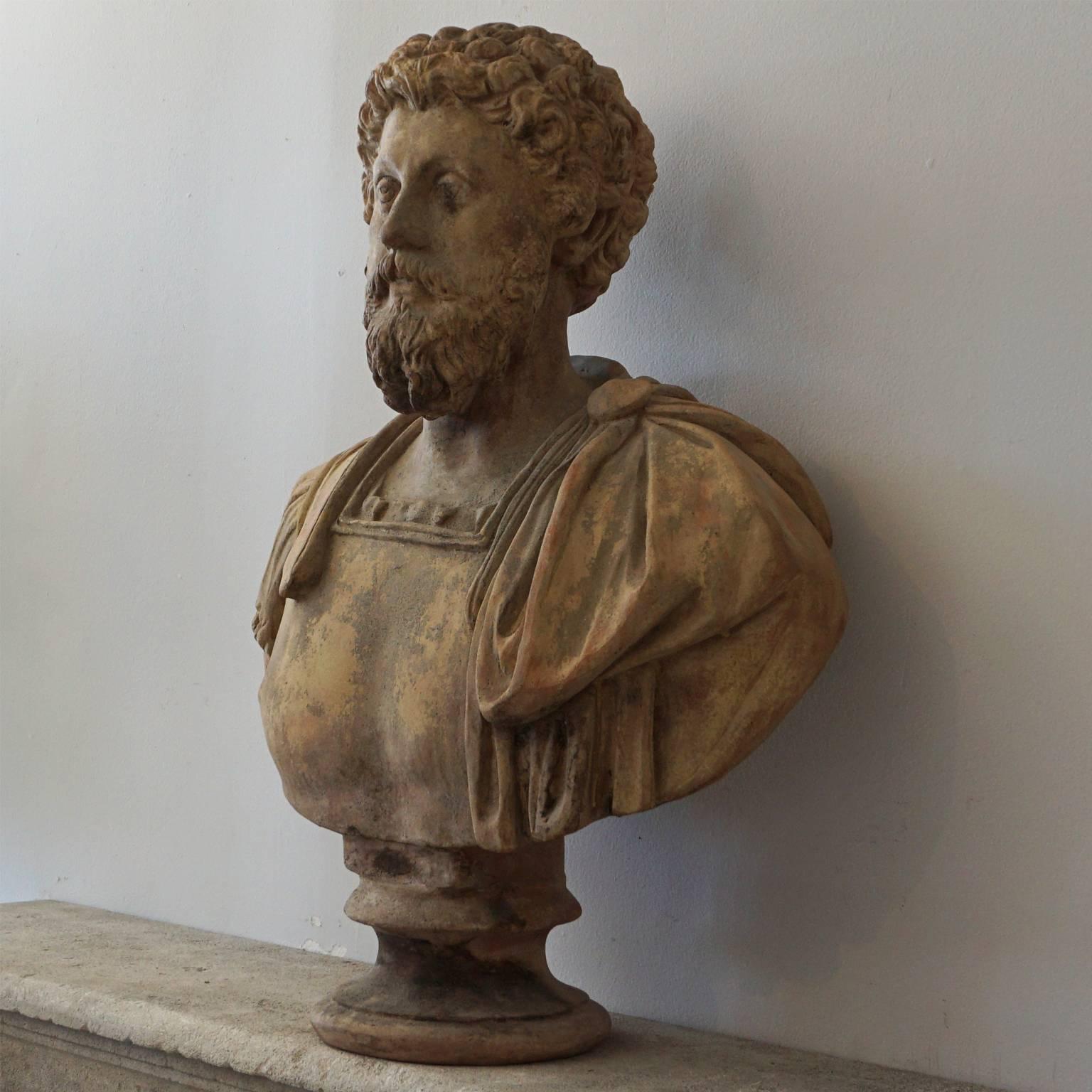 An antique Italian clay bust of the Italian emperor Marco Aurelio made of hand crafted Terra Cotta, raised on a round short base with an aged surface, in good condition. Wear consistent with age and use, Circa 1890, Italy.