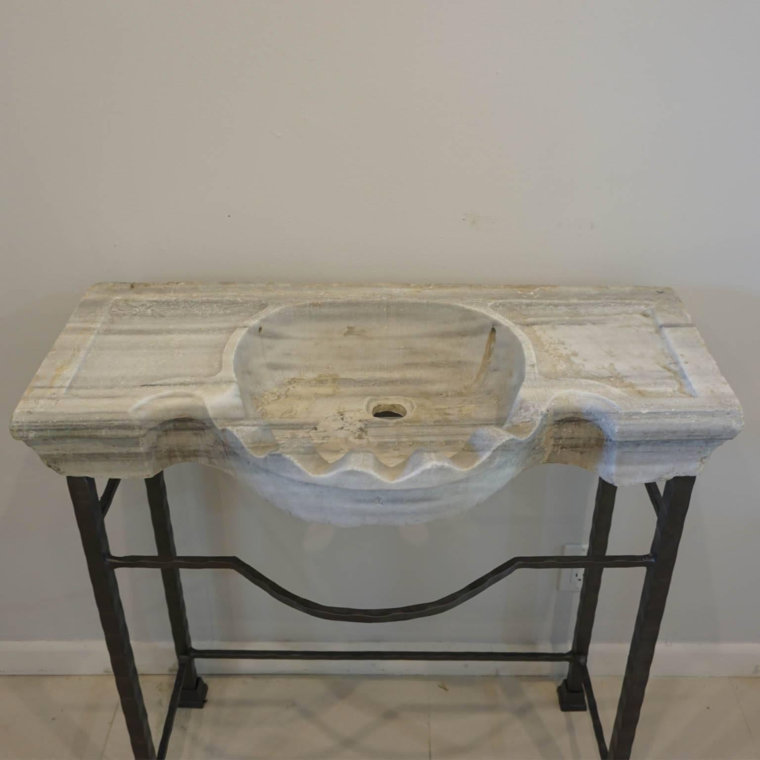 Antique Italian Carrara marble basin with a bowed scalloped sink cut-out on an contemporary iron stand. (Rome, circa 1860).