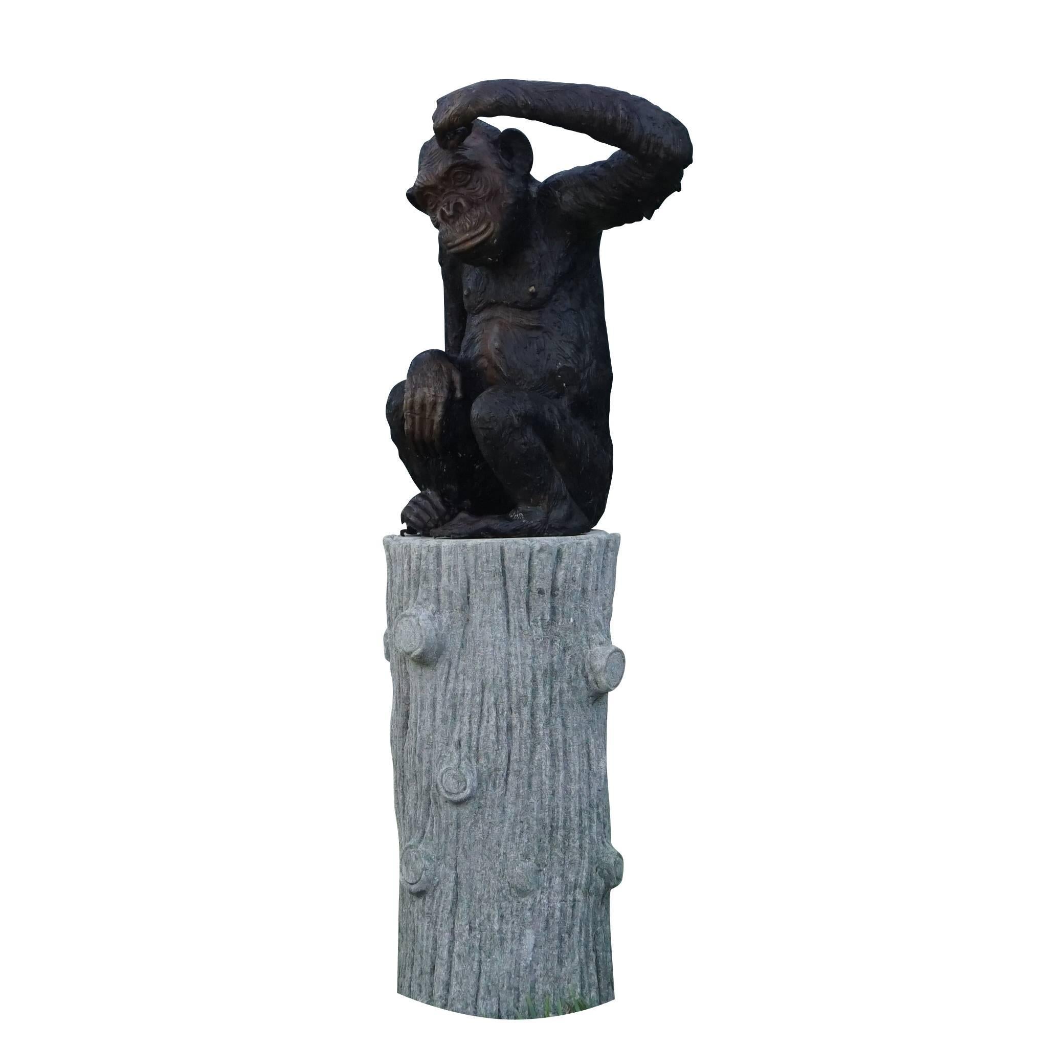 A vintage French bronze monkey statue is positioned onto a round faux bois tree trunk carved of solid limestone, in good condition. Wear consistent with age and use, circa 1920, Dijon, France.

Measures: Total statue height is 52