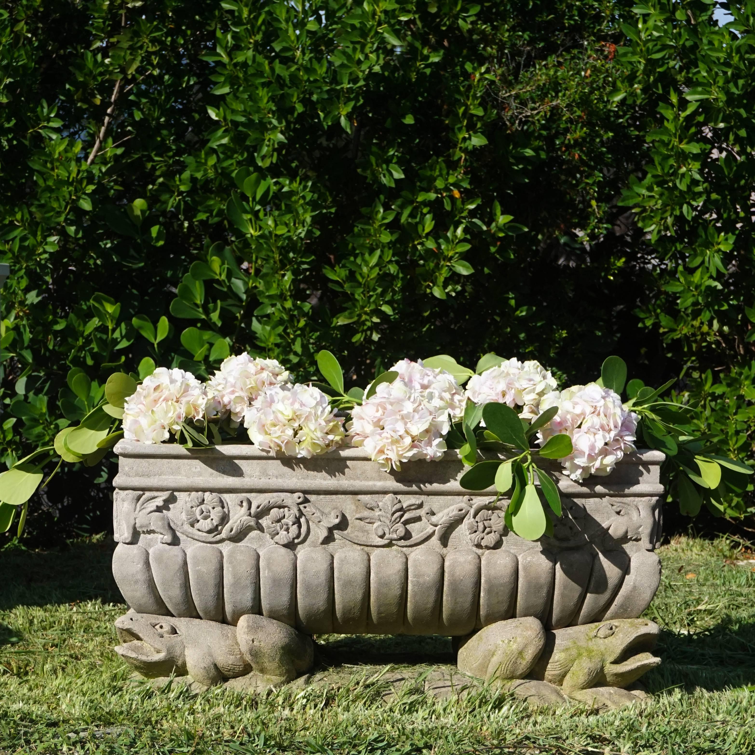 Heavily decorated frog trough with scrolls, florals and rosettes in hand-carved limestone and supported by four frog statuettes on each corner of the rectangular base, circa 1930, Italy.