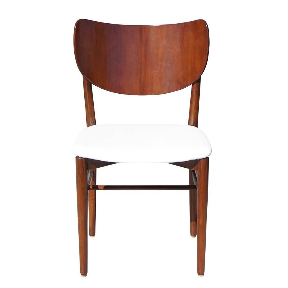 A vintage Mid-Century Modern Danish set of twelve dining chairs, designed by Nils and Eva Koppel for Slagelse Mobelvaerk, known for their chair models with large backs. The side chairs are newly upholstered and fumed with Oakwood, in good condition.