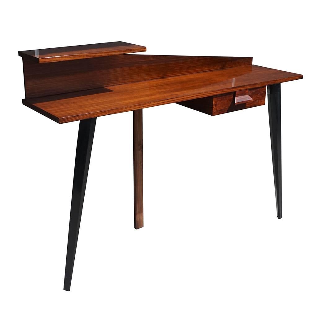 A vintage Mid-Century Modern Italian wall desk, writing table with three legs, one-drawer to the right and a small shelf to the left, made of hand carved Rosewood, in good condition. Wear consistent with age and use, circa 1960, Italy.
