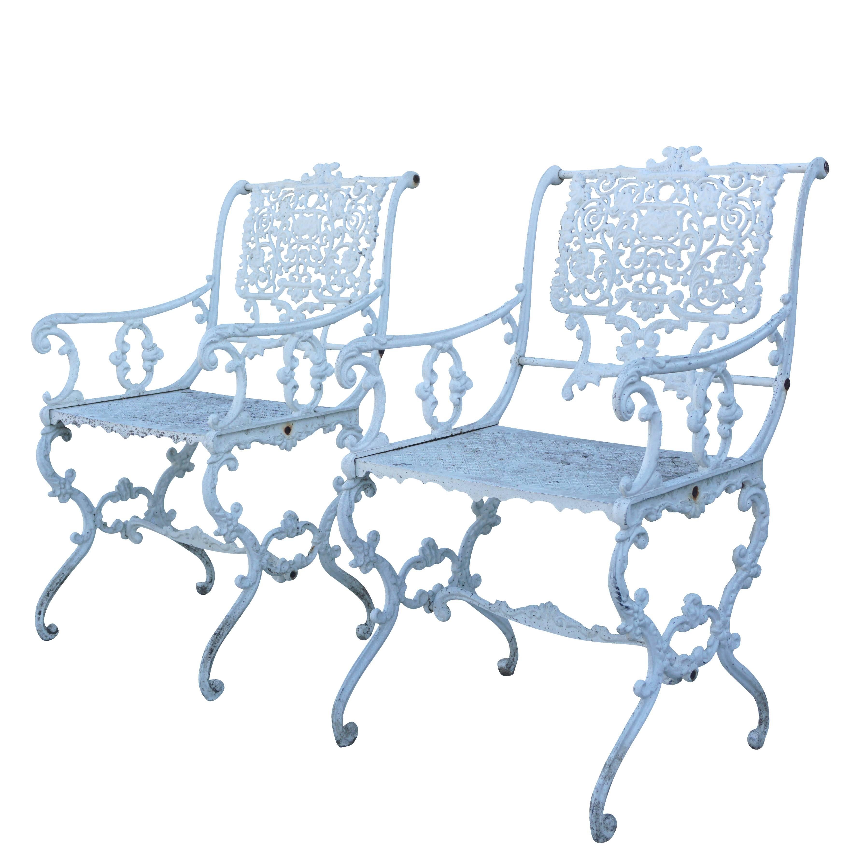 A pair of beautifully 19th century Victorian style cast iron garden fauteuils with armrests finished in a white oil based finish, circa 1860, England. Measures: Seat height 17