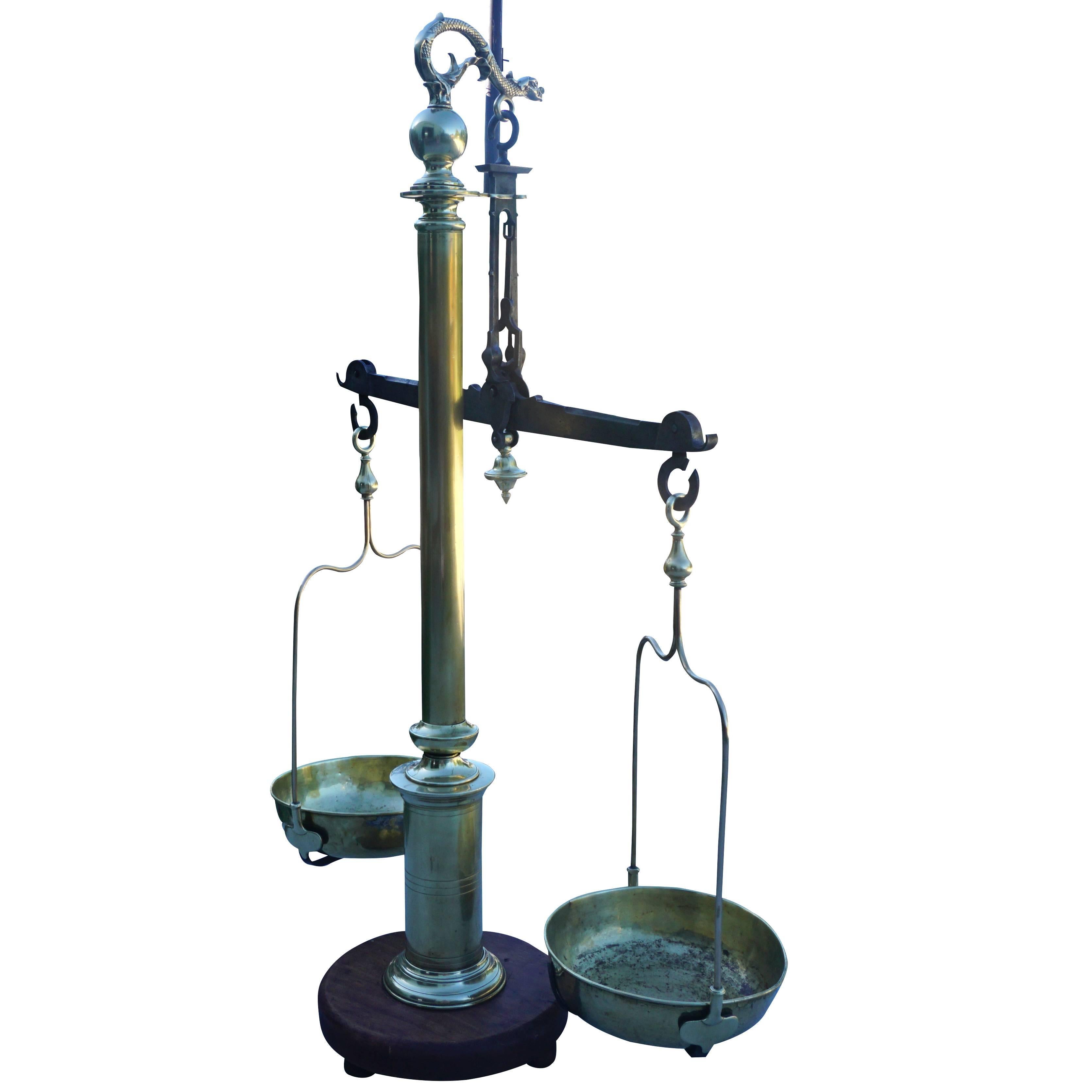 Antique, 19th century polished bronze and brass scale. This large-scale is a typical scale used in a French pharmacy in the 1800s. The top has a finial with a balance beam holding two brass platters, the arrow for equal balance is beneath the