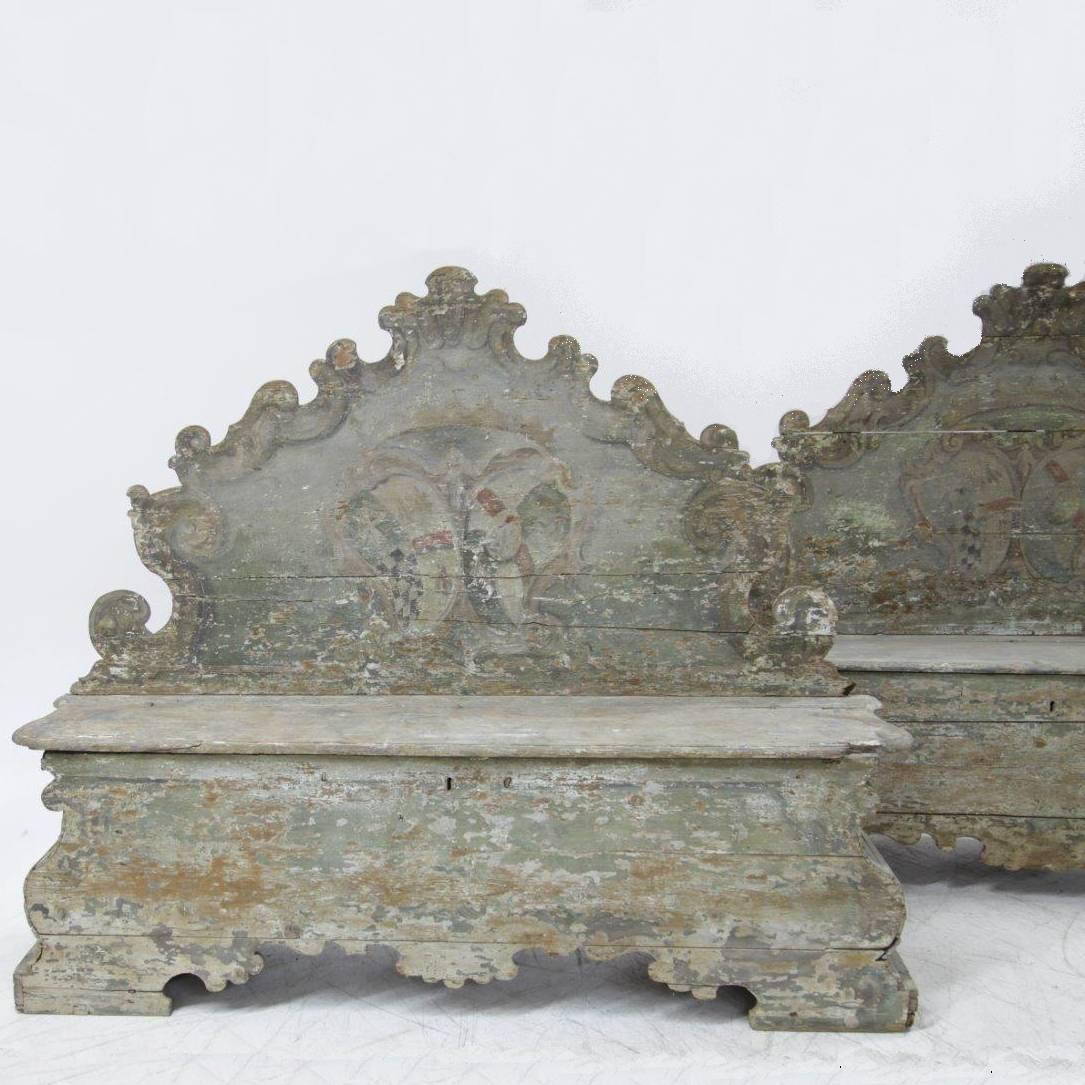 An antique pair of high quality Cassapanca Walnut benches with the original finish, decorated with typical Italian Baroque motifs. The Cassapanche were used as storage in a castle in Piedmont. The décor benches are in good condition with minor