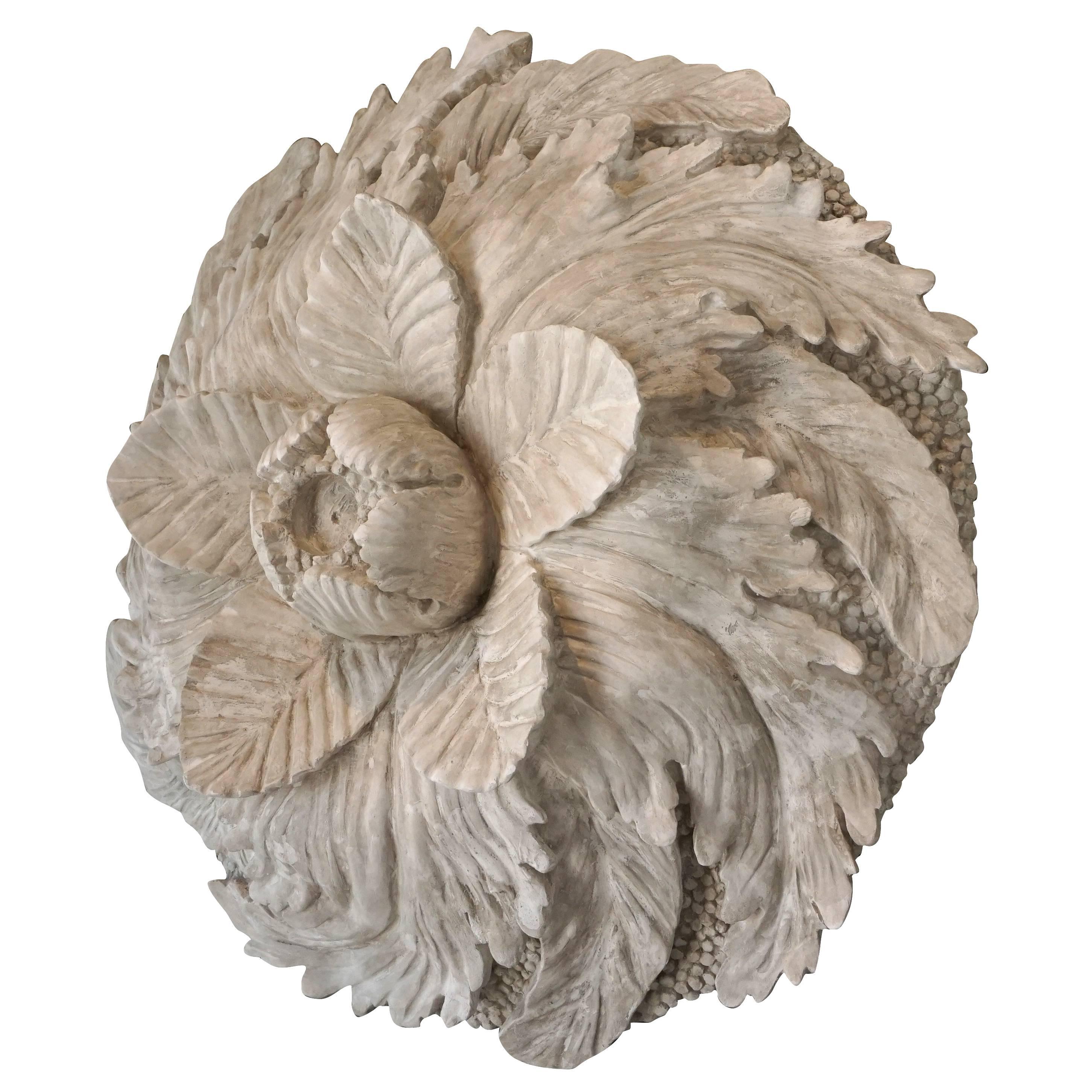 Wall mount large architectural element of a over sized rosette with details of the petals and a raised center, in French plaster.