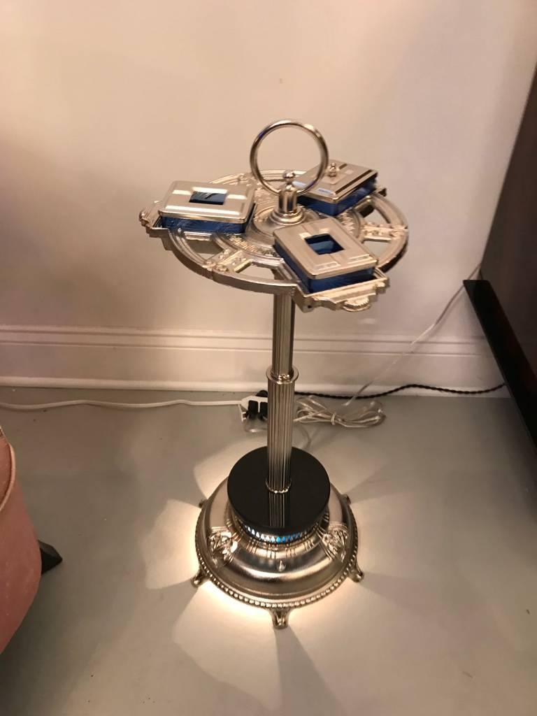 Stunning Art Deco standing ash tray having blue glass. Polished nickel frame having three blue glass ash trays with covers.