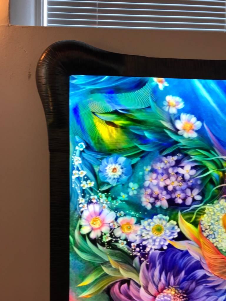 This gorgeous signed original Ulla Darni flat glass painting is reverse painted on glass with a hand-forged iron work frame. The colors are very vibrant. This truly is a one of a kind piece of art.