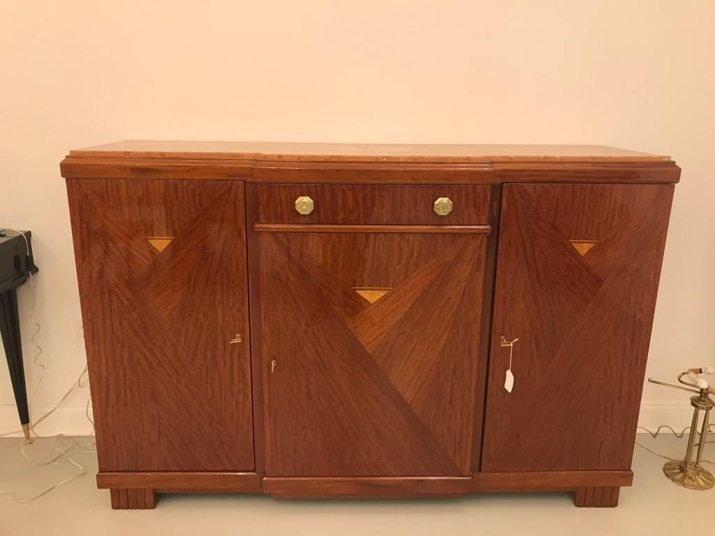 Stunning signed Louis Majorelle buffet. Having parquetry geometric inlay and beautiful marble top. The signature is branded on the side of the credenza. Brass hardware pulls having floral design that compliments the wood beautifully.