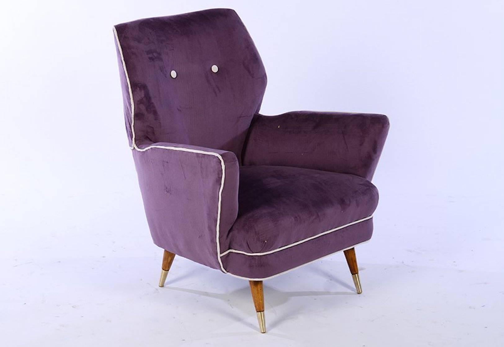 A pair of Italian Mid-Century Modern upholstered club chairs raised on turned and tapered legs with brass caps, circa 1960. Very stylish. 

 