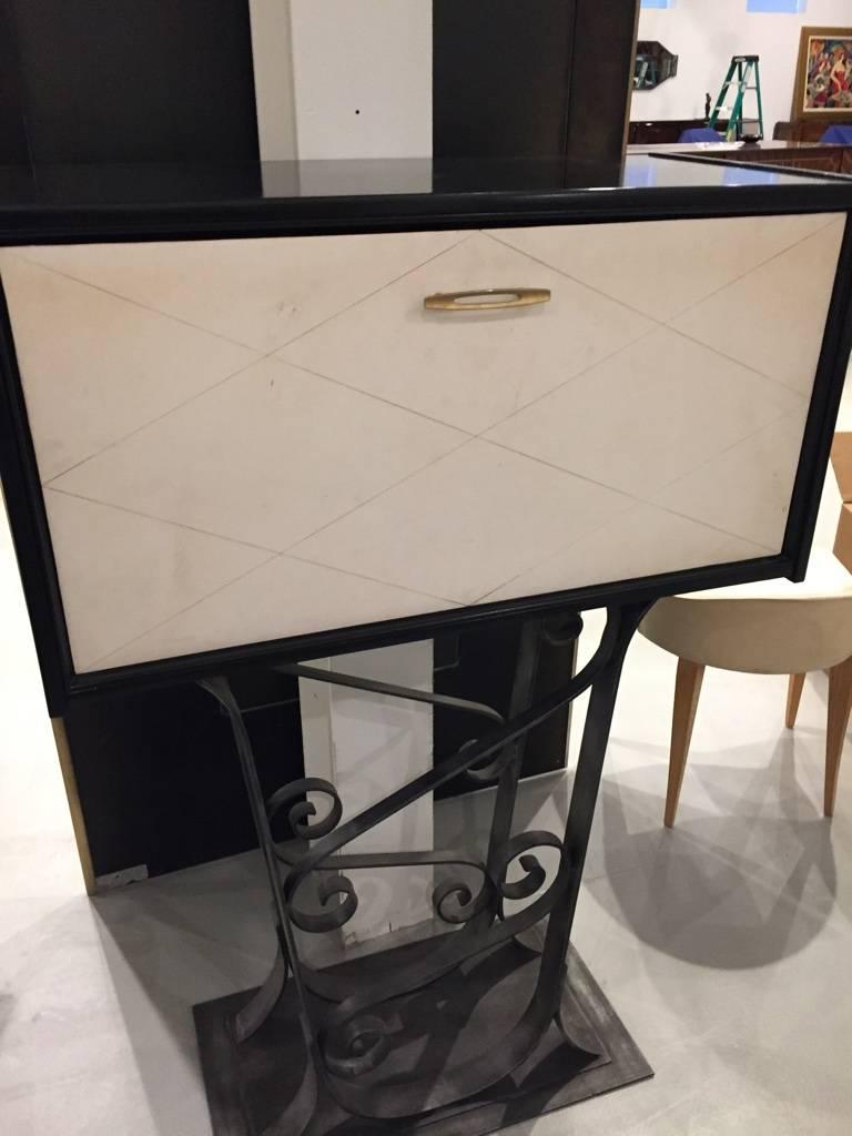 French Art Deco parchment dry bar with black lacquered iron base. The front drop down to open into a dry bar, having the original parchment. Plenty of space inside the dry bar for all the essentials. 

 