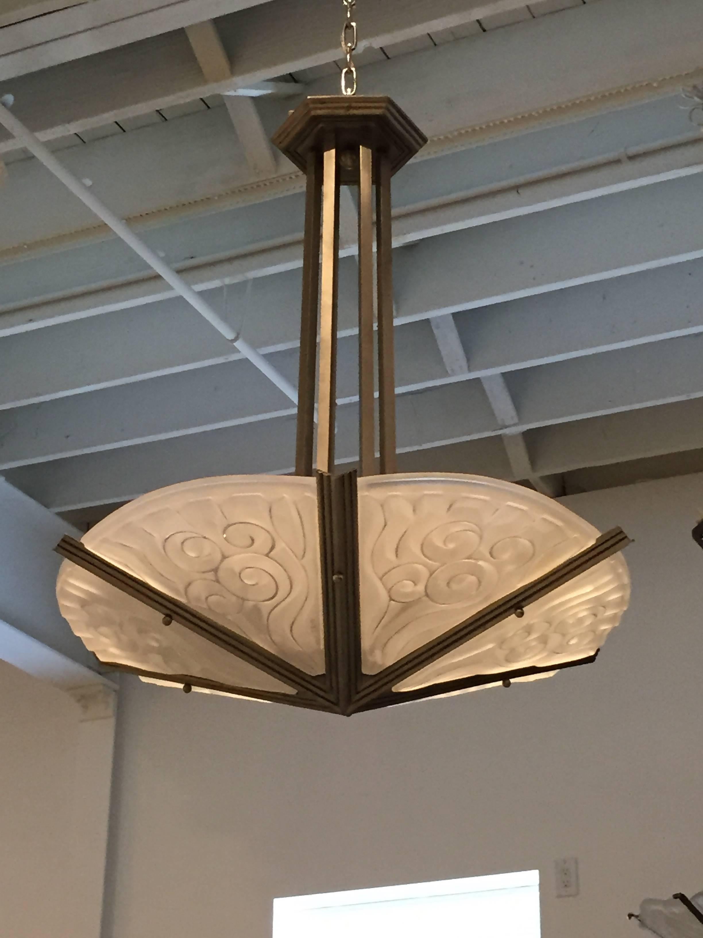 French Art Deco chandelier by the French artist David Gueron Degue. Shades are in clear frosted glass with geometric motif details. Supported by nickel matching layered multi-tiered design frame. Has been rewired for American use with six candelabra