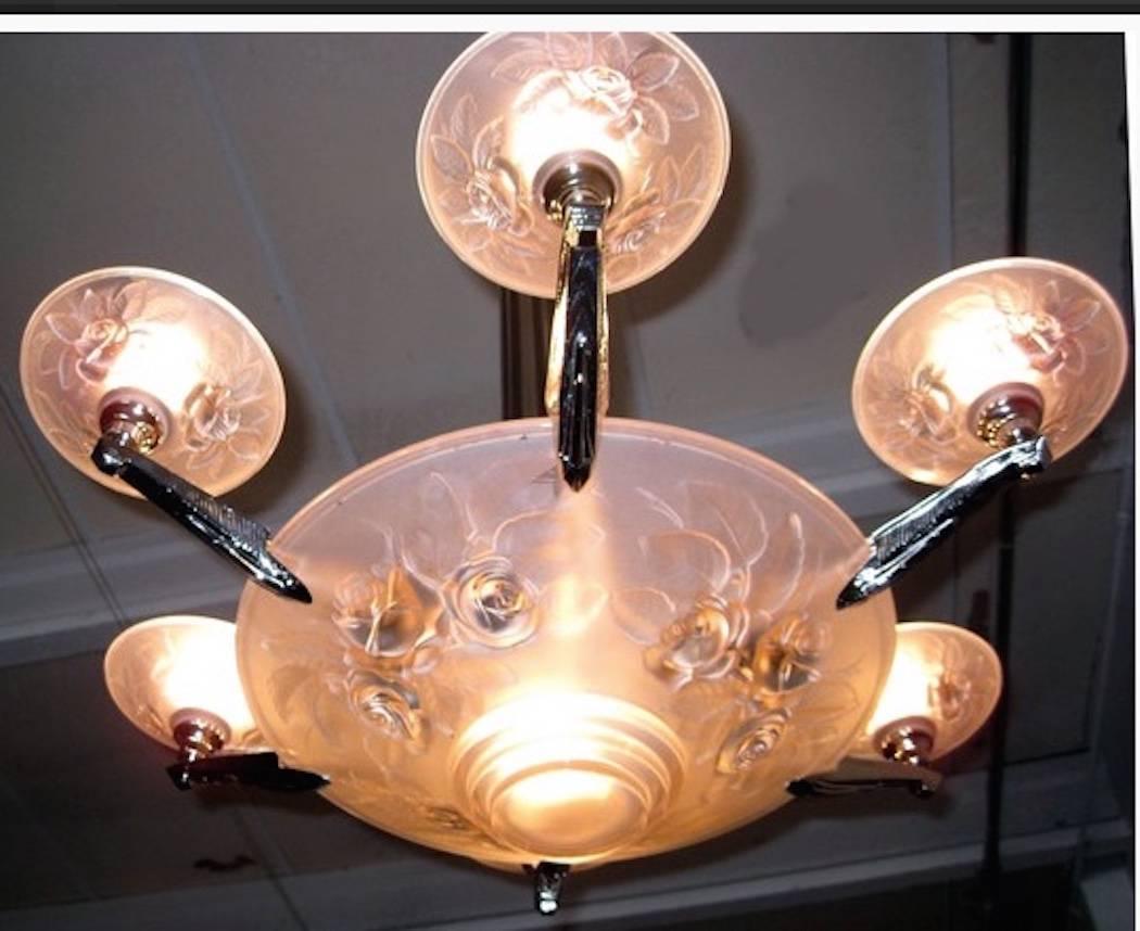 Beautiful French Art Deco chandelier by Muller Freres Luneville. Center peach glass bowl is surrounded by six smaller peach glass bowls. All the glass is held by polished nickel design frame. The glass is signed “Muller Freres, Luneville”. The