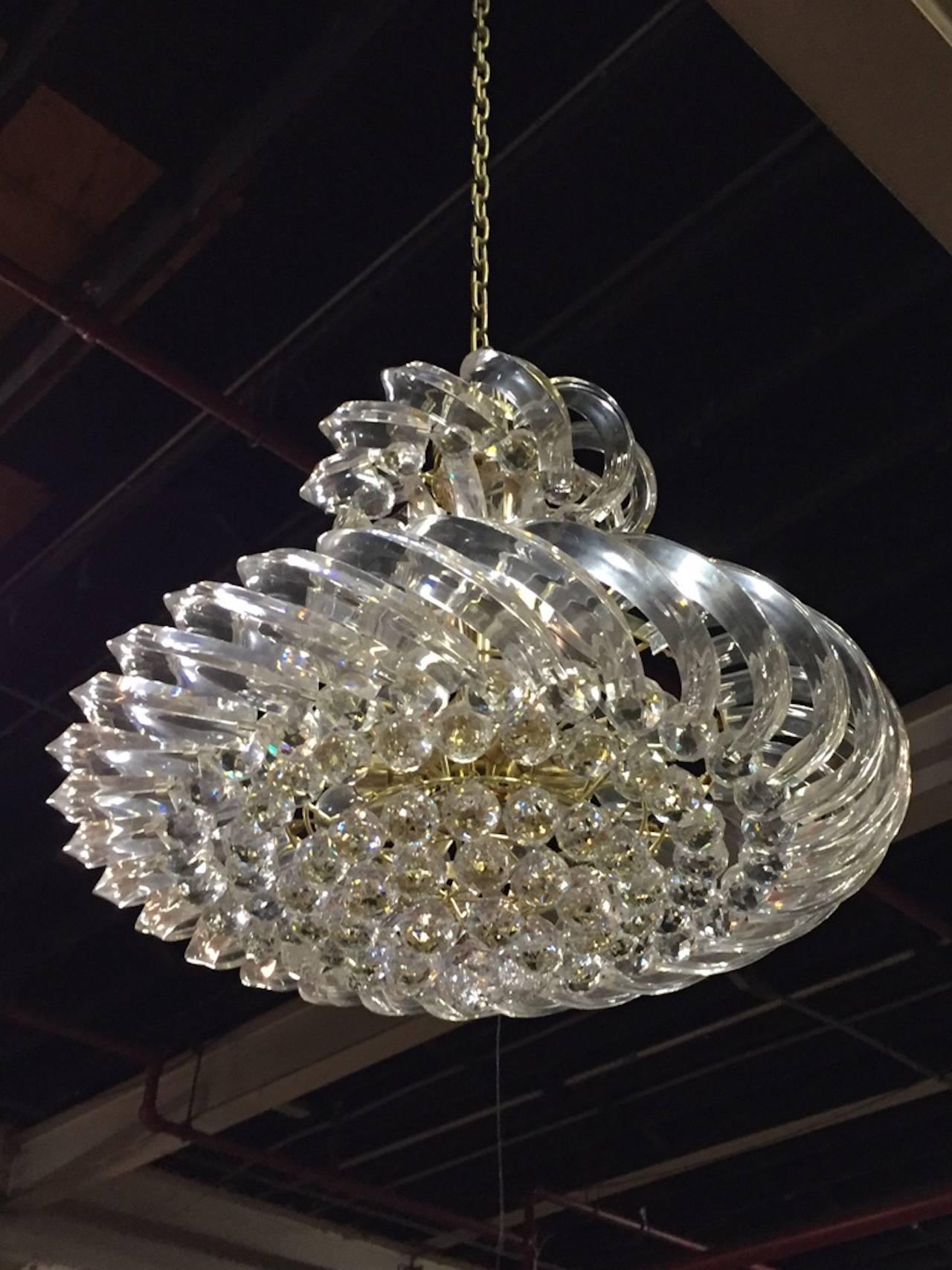 This Mid-Century Modern Italian Lucite chandelier is stunning. Highly Glamours style is perfect for every space. Having a beautiful brass frame. Any amount of chain can be added for custom hanging length. 