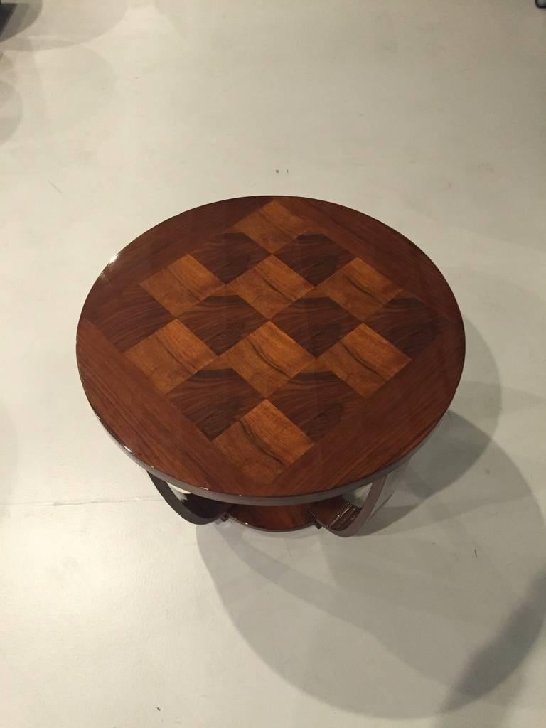 A stunning French Art Deco center table, circa 1930s. Beautiful wood and has been restored with a high French polish. Very stylish legs.