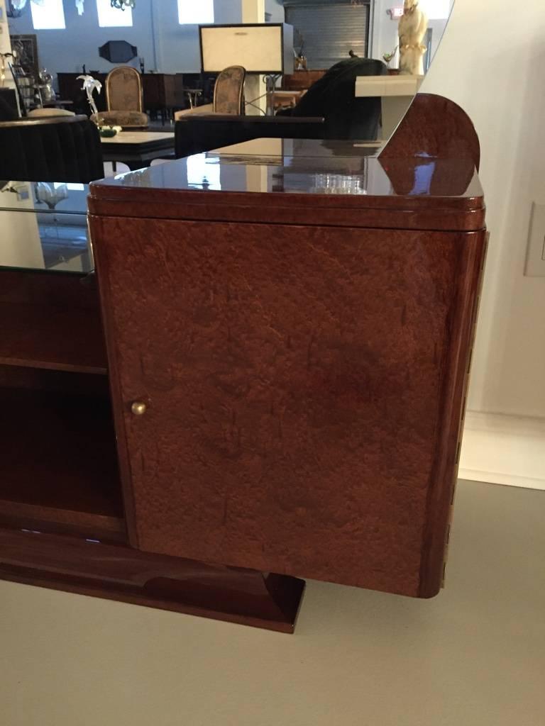 Spectacular Art Deco  vanity with large round mirror from the 1920s. having a cabinet door to the right with silver hardware and removable glass counter.