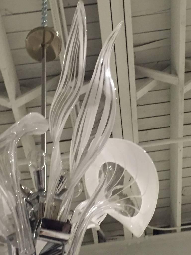 Italian Mid Century Modern Murano handblown chandelier. Having clear and white glass. Held by a chrome frame. Has been rewired for american use. 