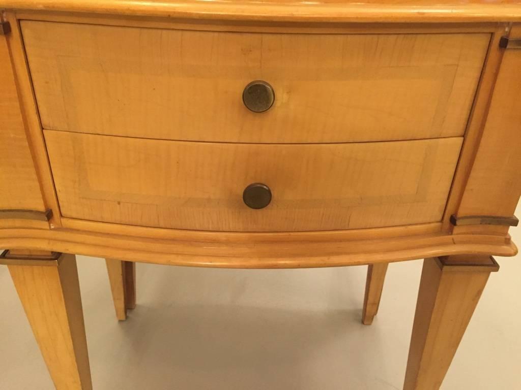 A pair of Andre Arbus style end tables having shaped top over two bow front drawers supported on bronze mounted tapered legs. 