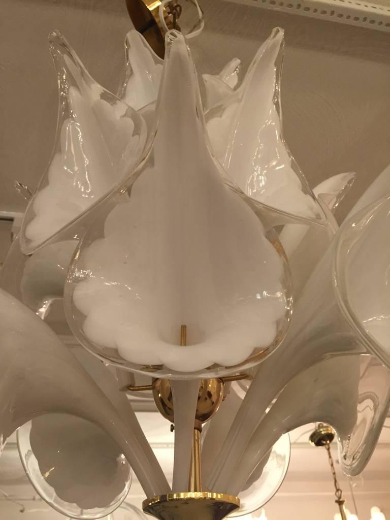 Large and unusual calla lily flower chandelier made in Italy by Camer. This high quality fixture has lily shaped pieces of handblown white and clear glass that are installed on a brass framework. The original ceiling cap is included. It has a great