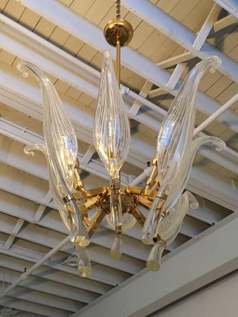 Stunning Mid-Century Modern/Hollywood Regency handblown glass chandelier by Seguso for Murano in a clear and white color. Fixture features eight cattail glass leaves which set in a brass frame.